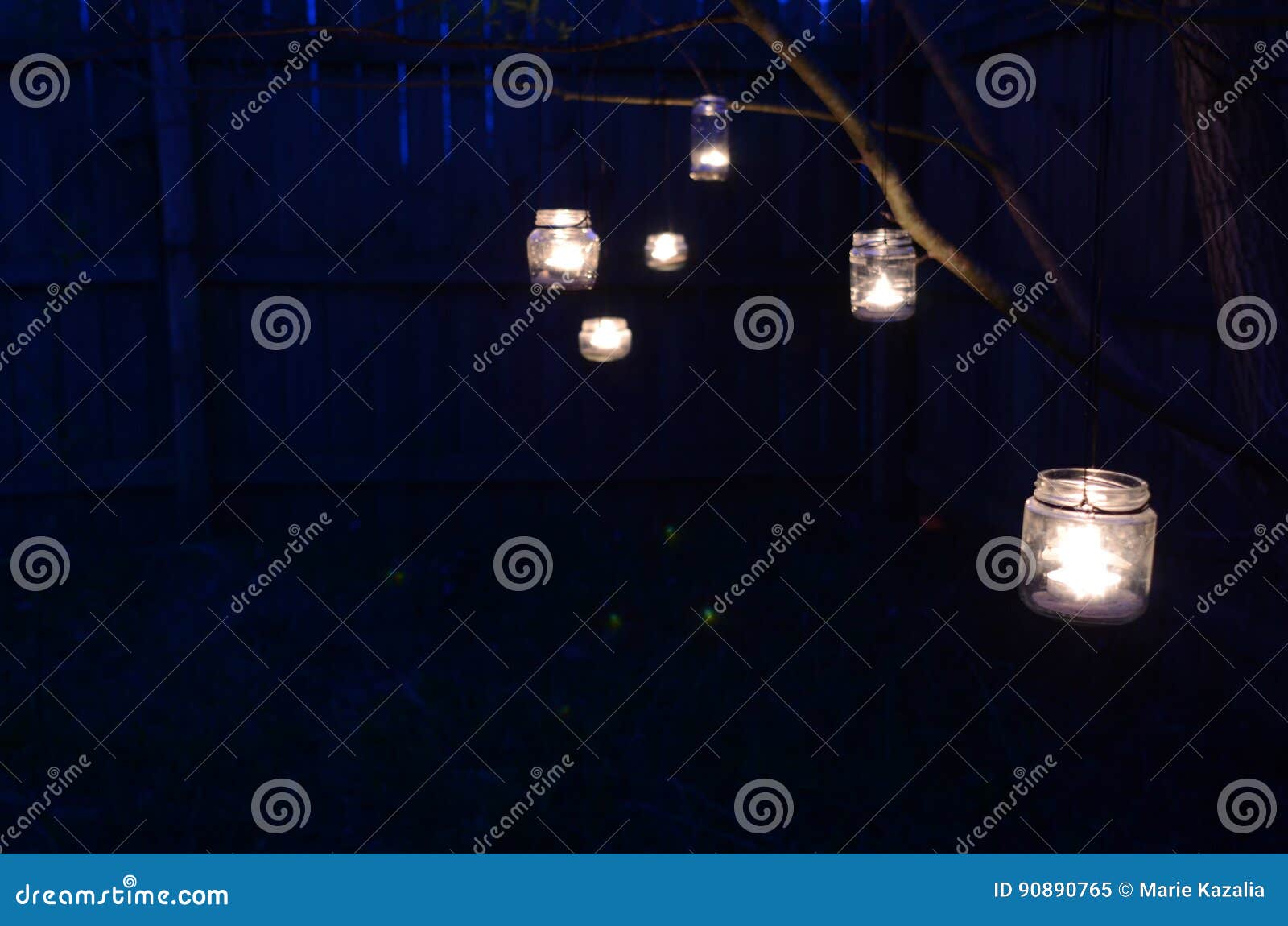 Night Scene Candles in Jars Hanging on Tree Branches Stock Image