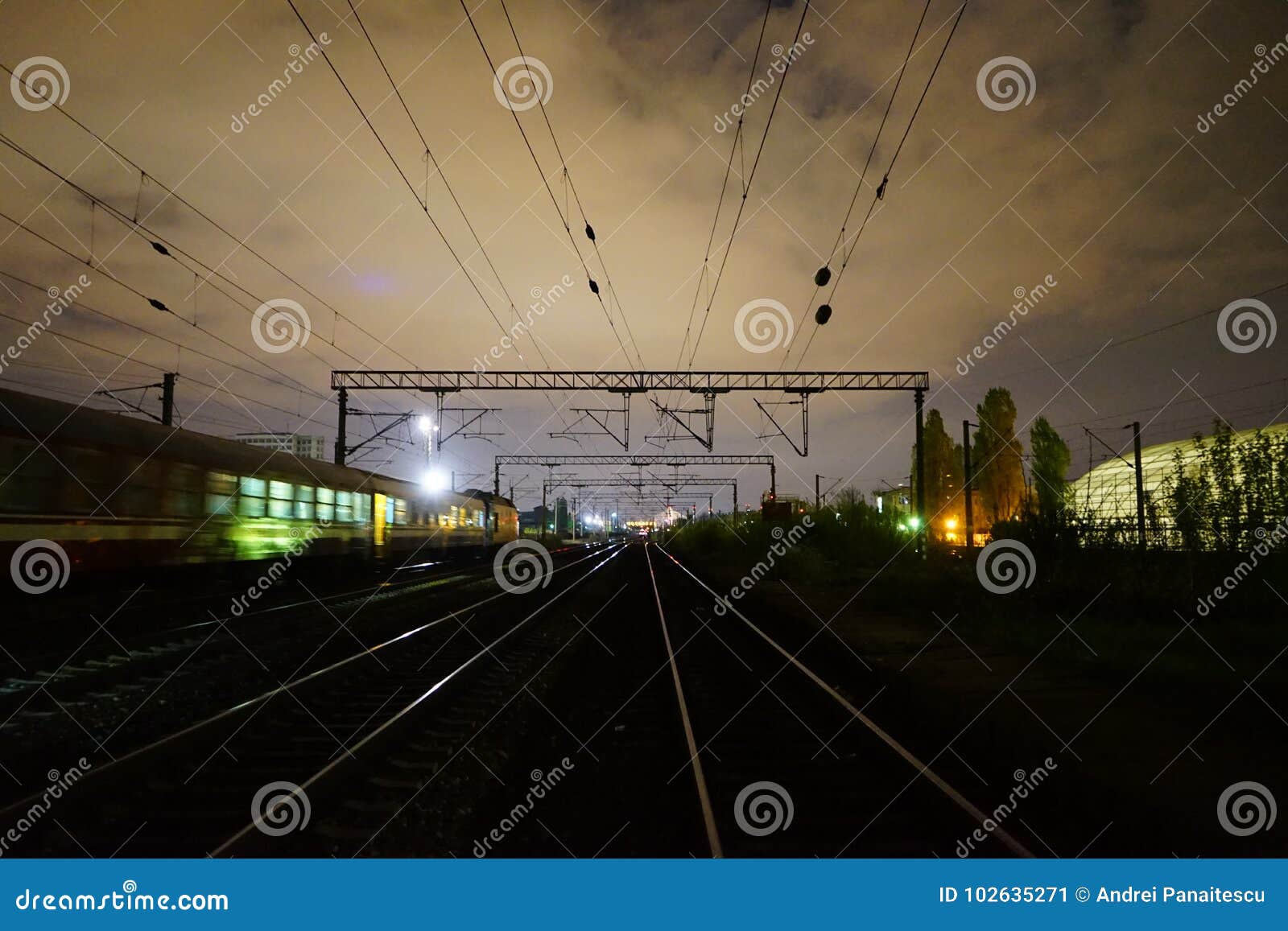 night scene of rails and train in carpati station, bucharest, cfr