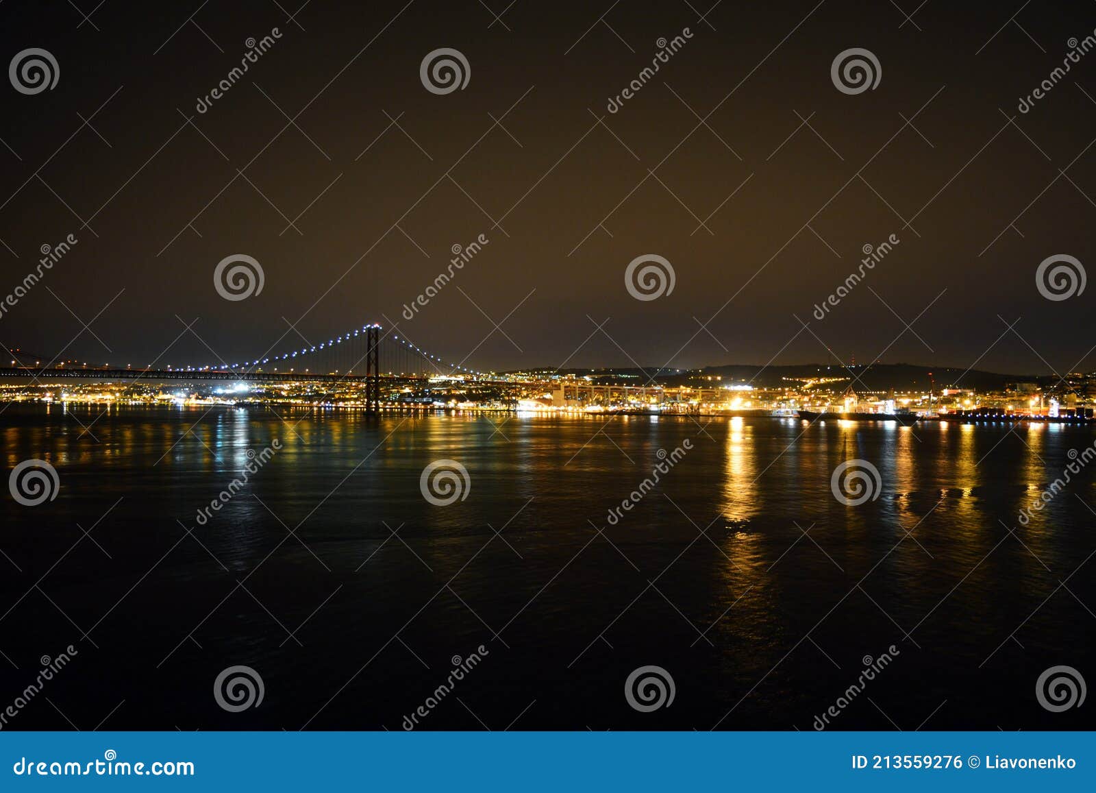 night tejo river. 25thth april bridge. lisbon. almada. portugal. nightscene. lights  colors dark background. landscape