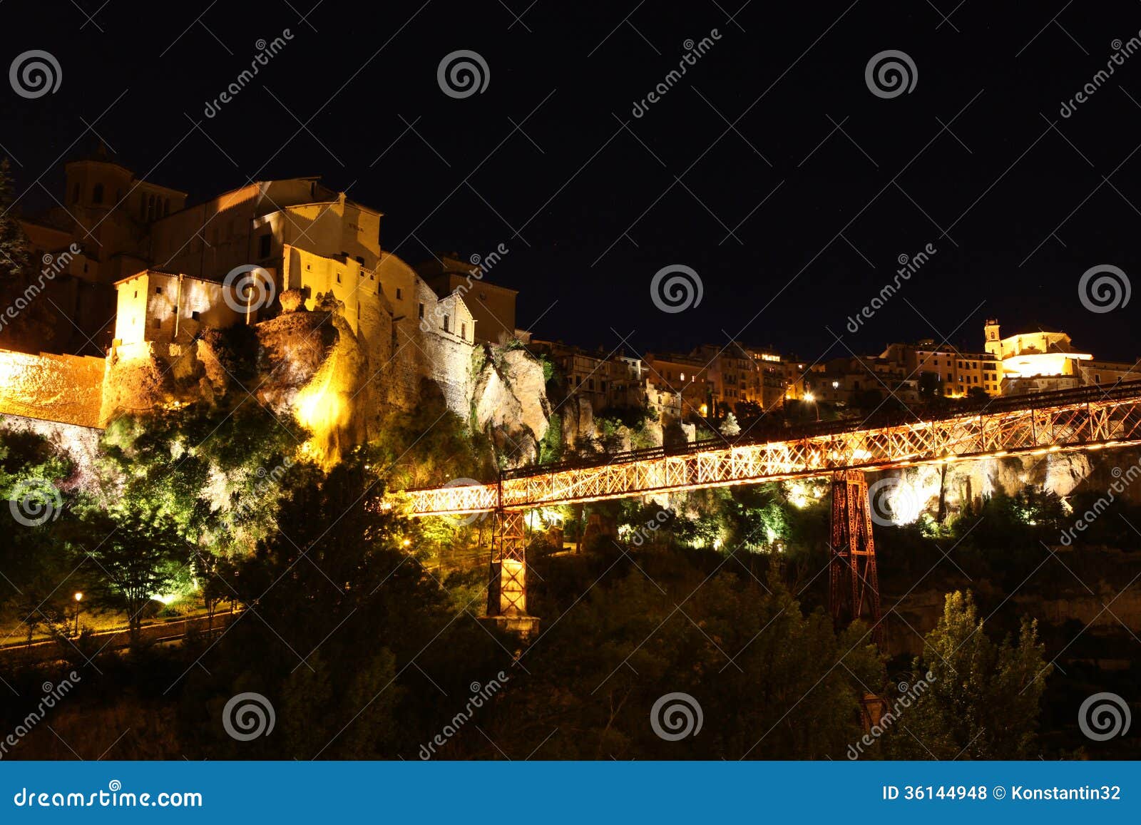 night view on rocky river bank jucar and bridge in cuenca. casti