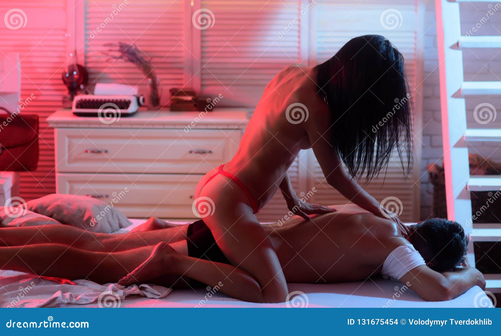 Night Woman and Good Night. Couple Relaxed in Bed. Woman Make Sensual Massage