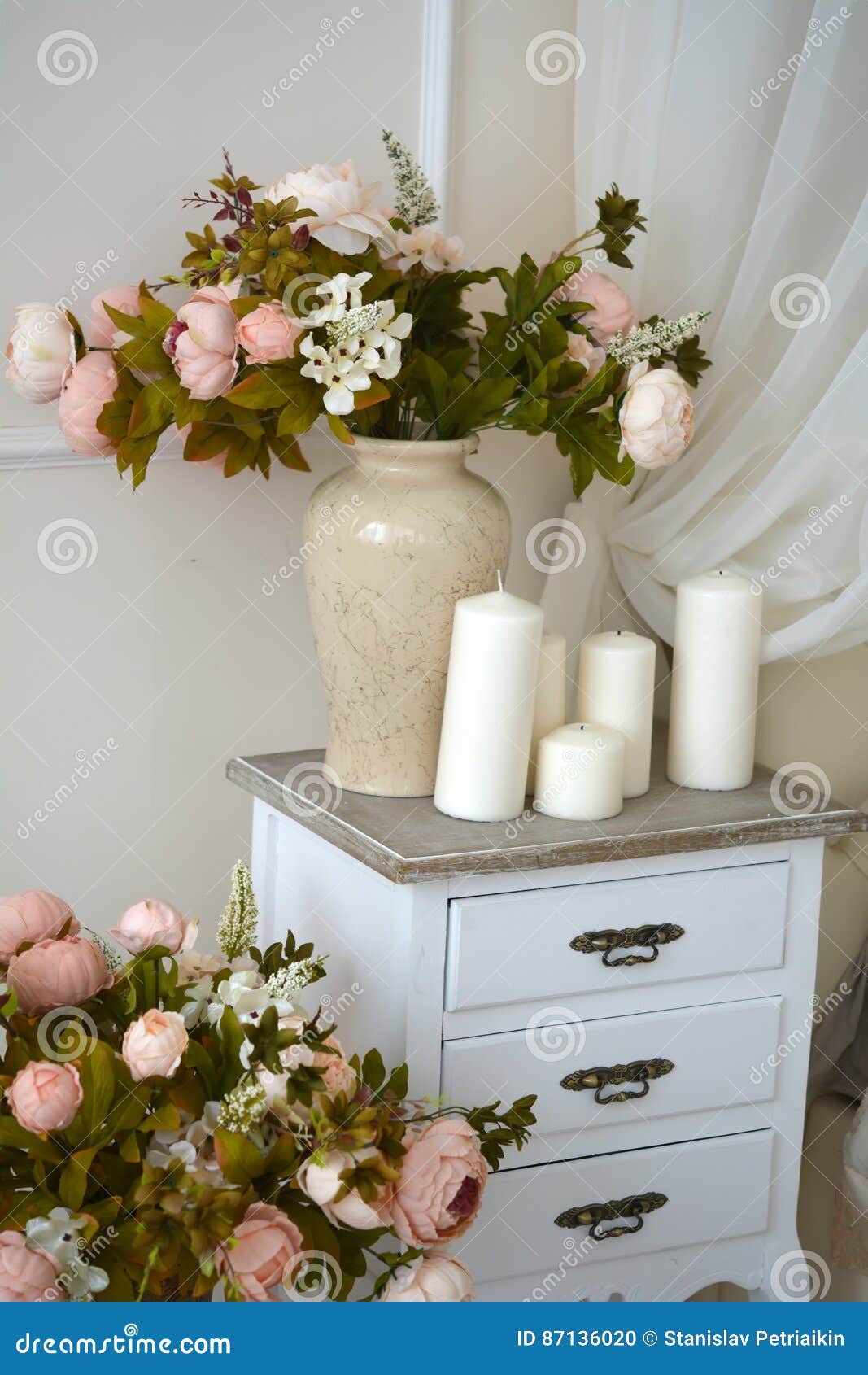 On the Nightstand beside the Bed is a Vase with Flowers and Candles