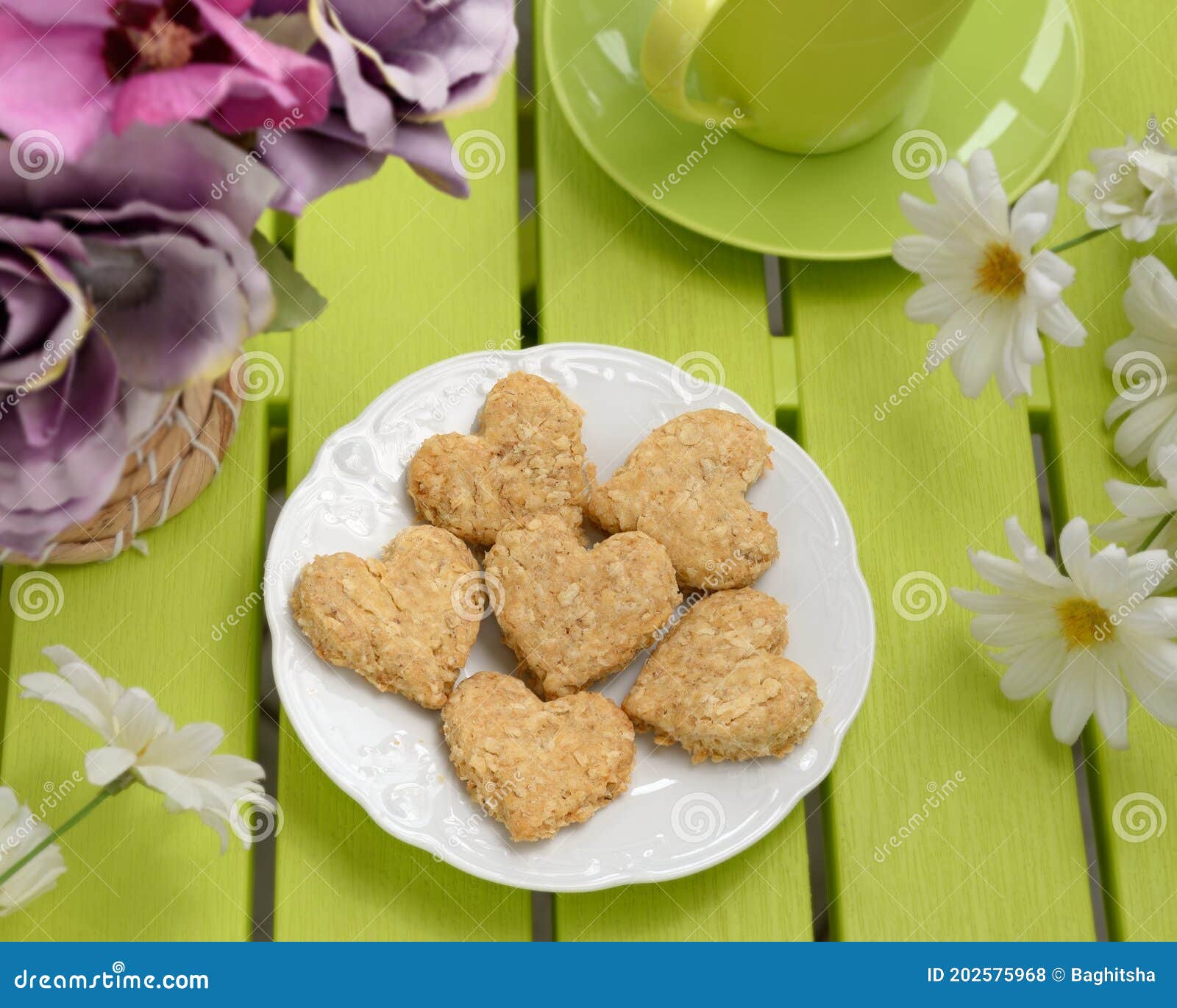 Oatmeal Homemade Heartshaped Cookies Flowers on Green Table Stock