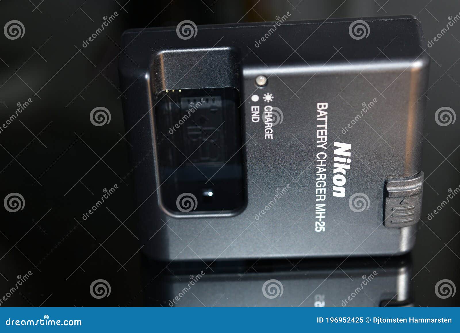 Nikon battery charger with editorial image. Image of camera 196952425