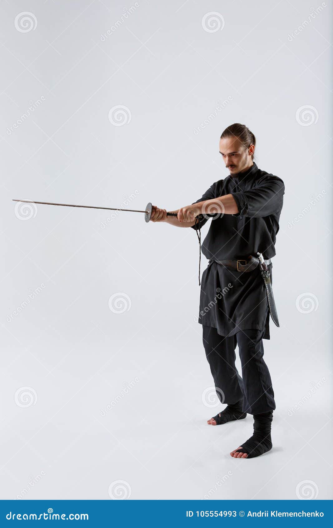 A Ninja Man Holding a Sword with Both Hands is Directed Forward Against a  Gray Background Stock Image - Image of flexibility, japanese: 105554993