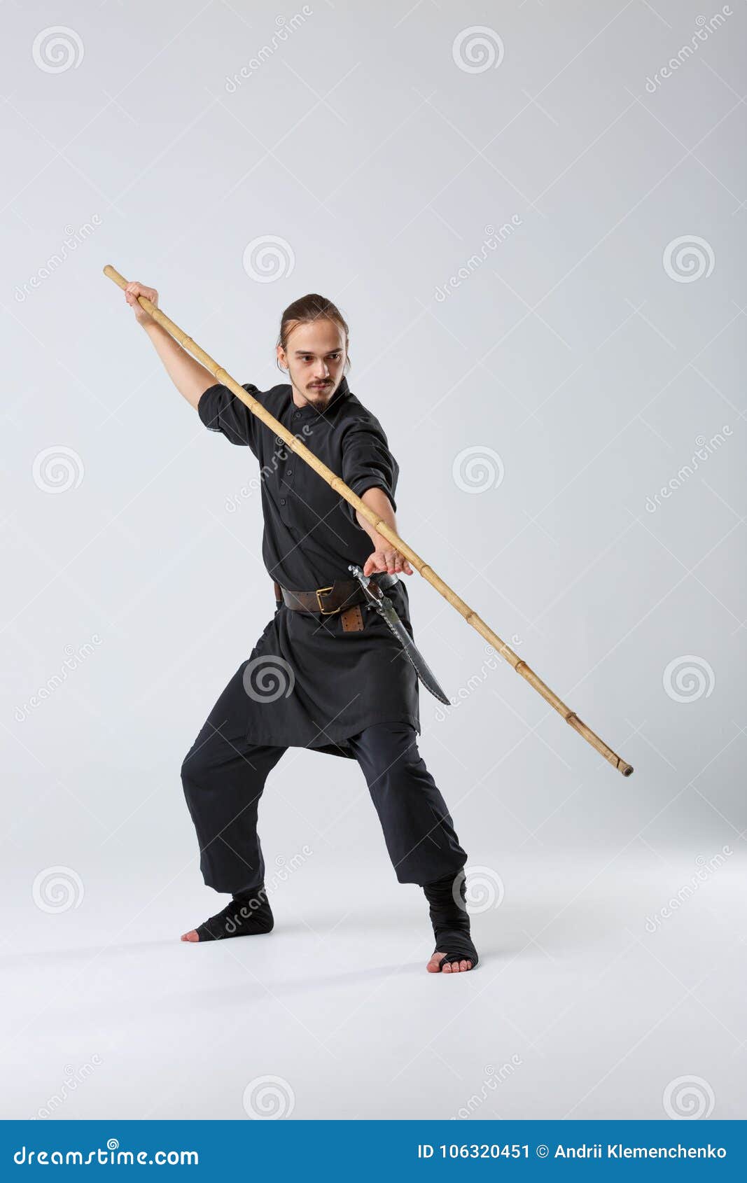 A Ninja Man is Practicing Fighting with a Bamboo Fighting Stick