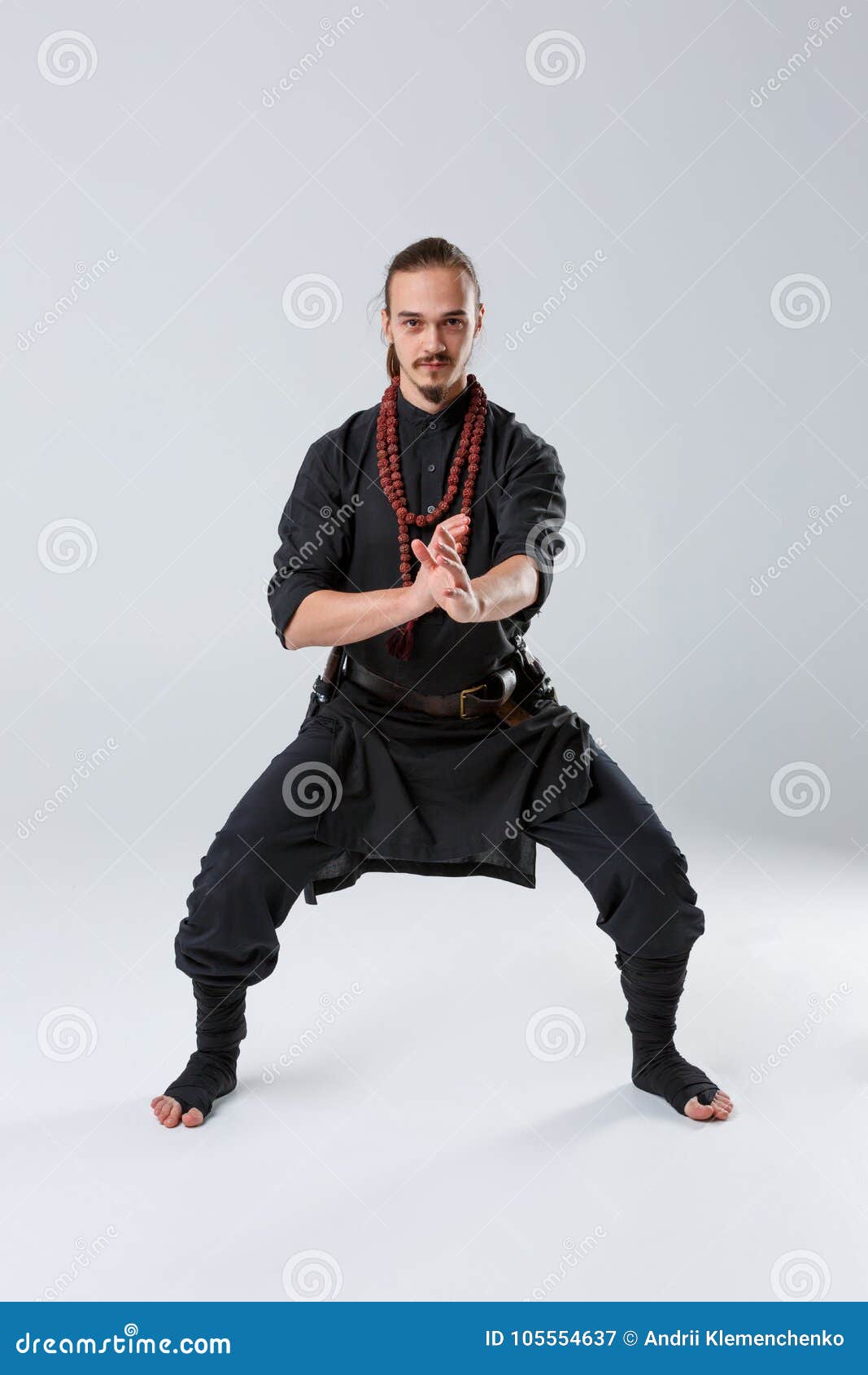 A Ninja Man Stands in a Fighting Stance Against a Gray Background. Front  View Stock Image - Image of aggression, combative: 105554637