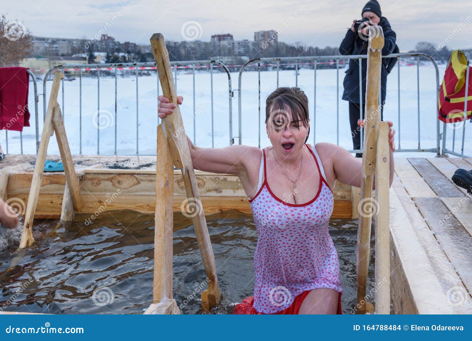Woman Bathes Into Cold Water Of Ice Hole On Epiphany Day