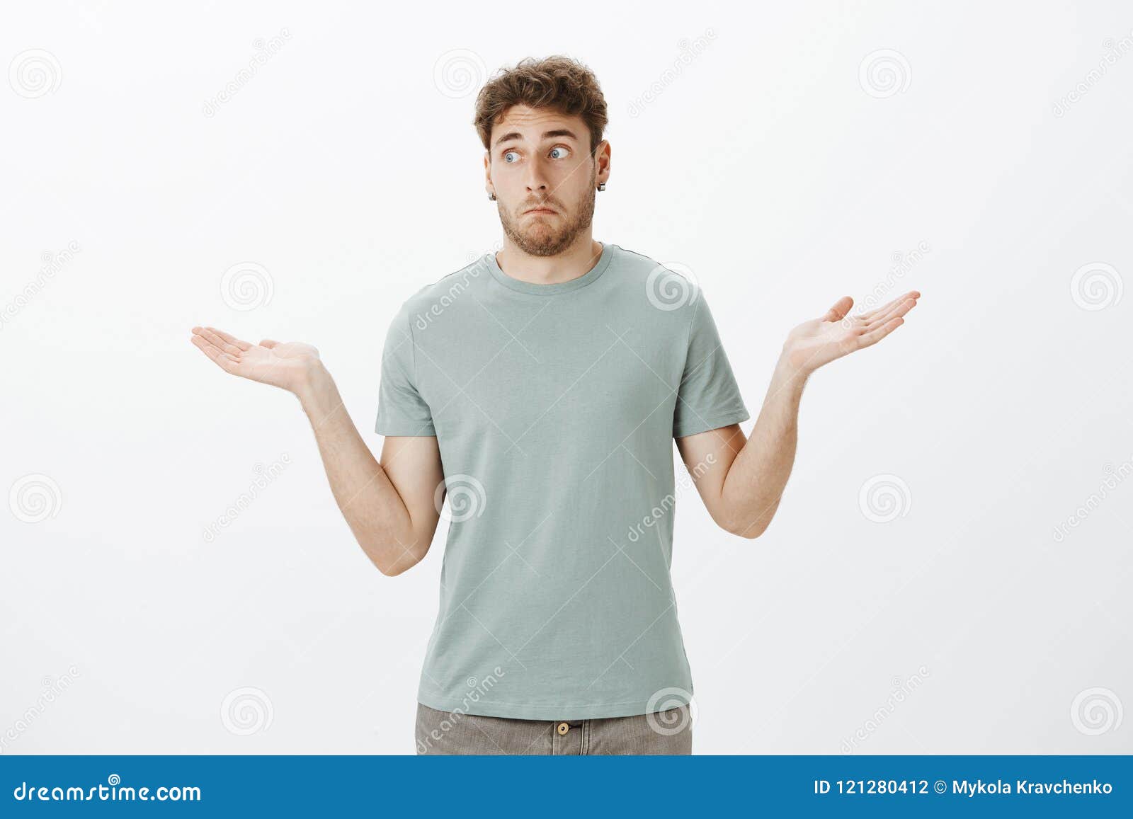No Idea How It Happened Portrait Of Awkward Unaware Funny Guy In T Shirt And Earrings Making Clueless Expression And Stock Photo Image Of Earrings Business 121280412
