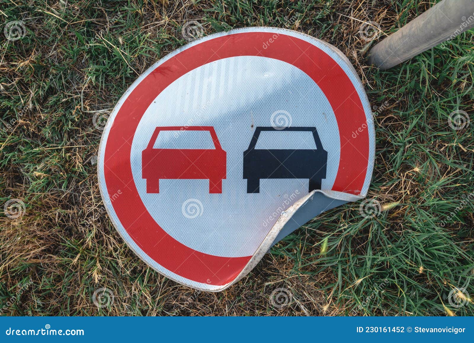 no overtaking traffic sign knocked on the ground