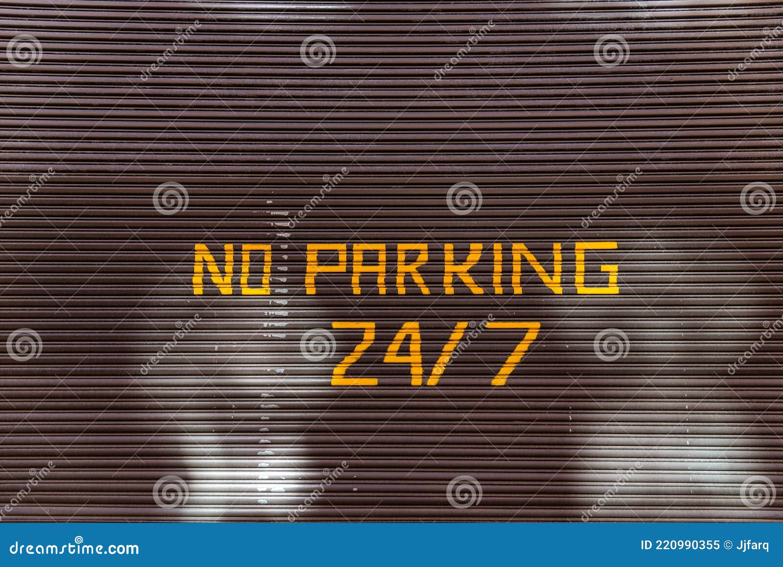 no parking 24, 7 text painted on garaje door