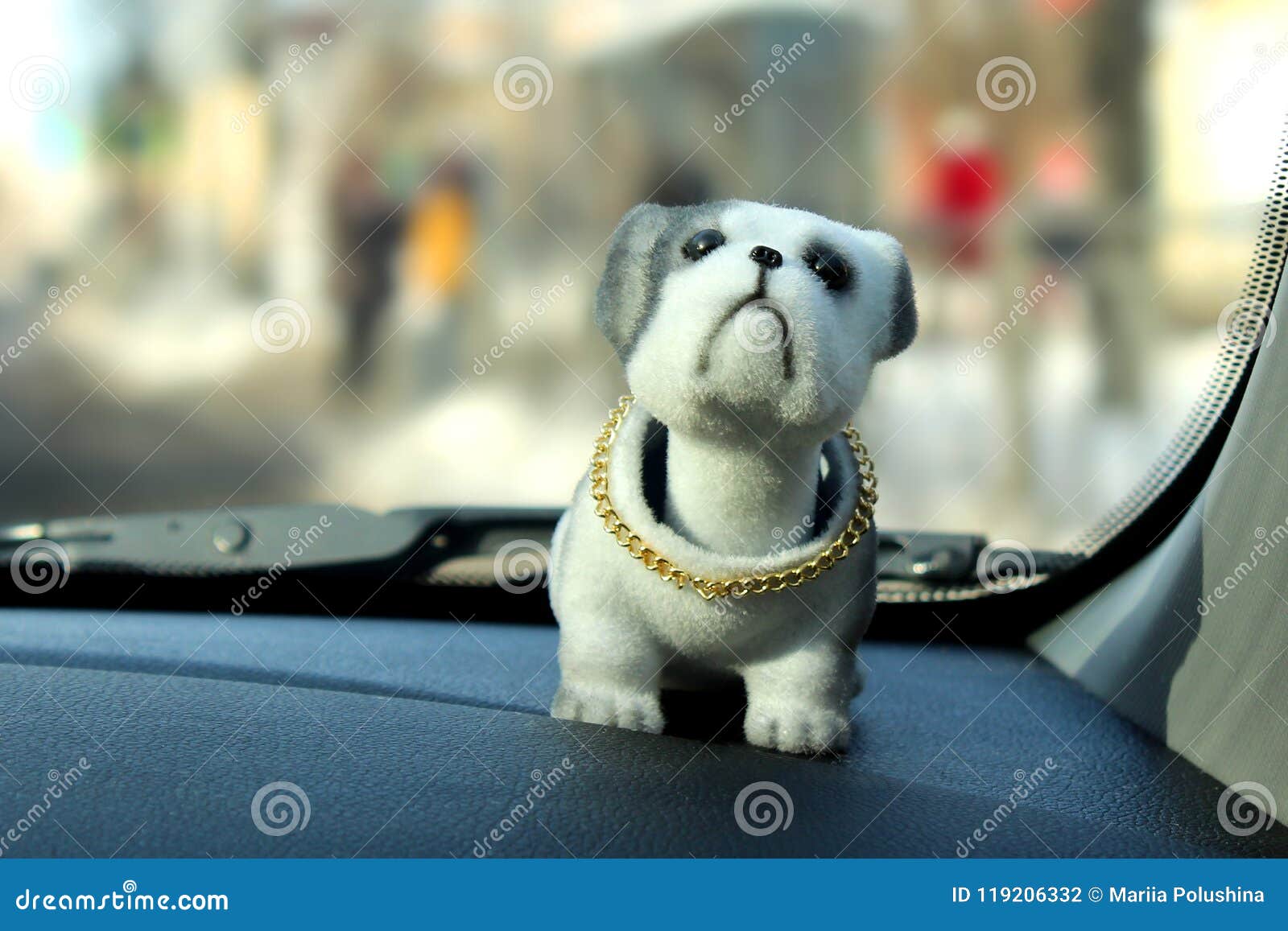 A Nodding Toy Dog on the Dashboard of a Car on a Window Background