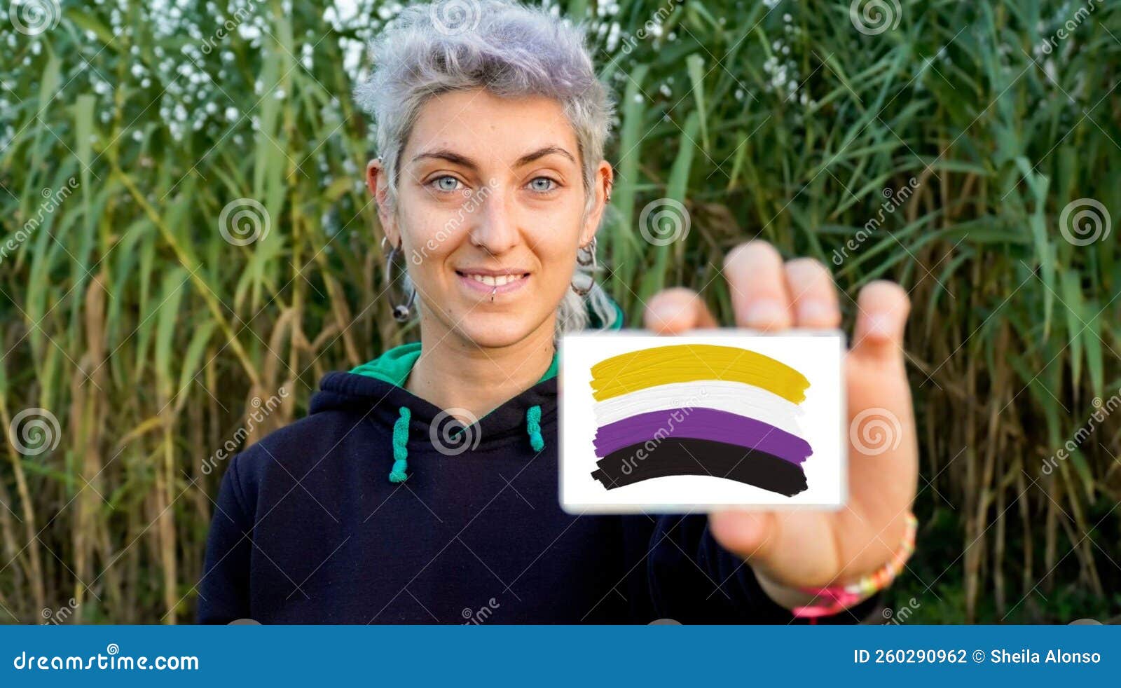 Non Binary Person Claims Gender Identity With A Non Binary Flag Stock Non Binary Person Claims Gender Identity With A Non Binary Flag Stock