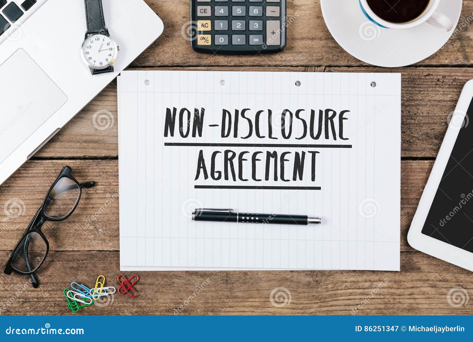 non-diclosure agreement on notebook on office desk with computer