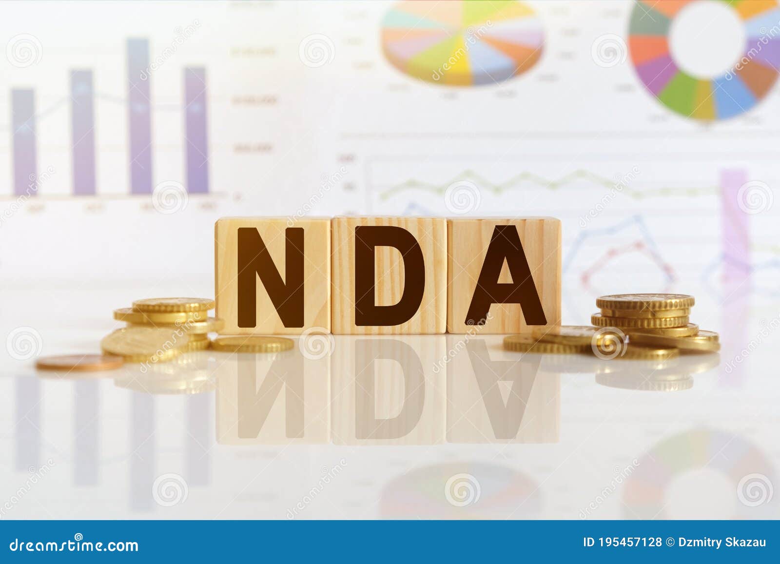 nda the word on wooden cubes, cubes stand on a reflective surface, in the background is a business diagram