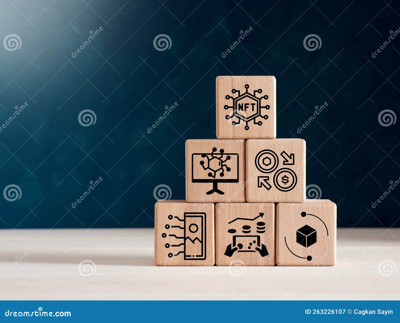 non fungible token nft transaction icons on a wooden cube pyramid