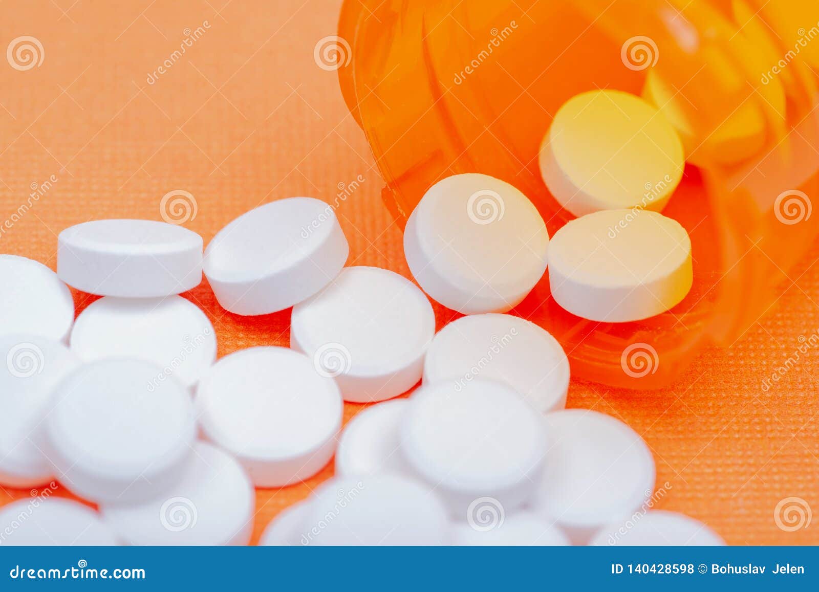 non-steroidal anti-inflammatory drugs. acetaminophen white tablets on orange