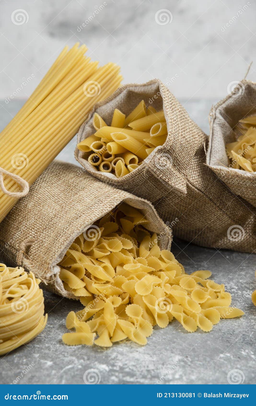Noodle and Pasta Varieties in Rustic Baskets and Marble Background