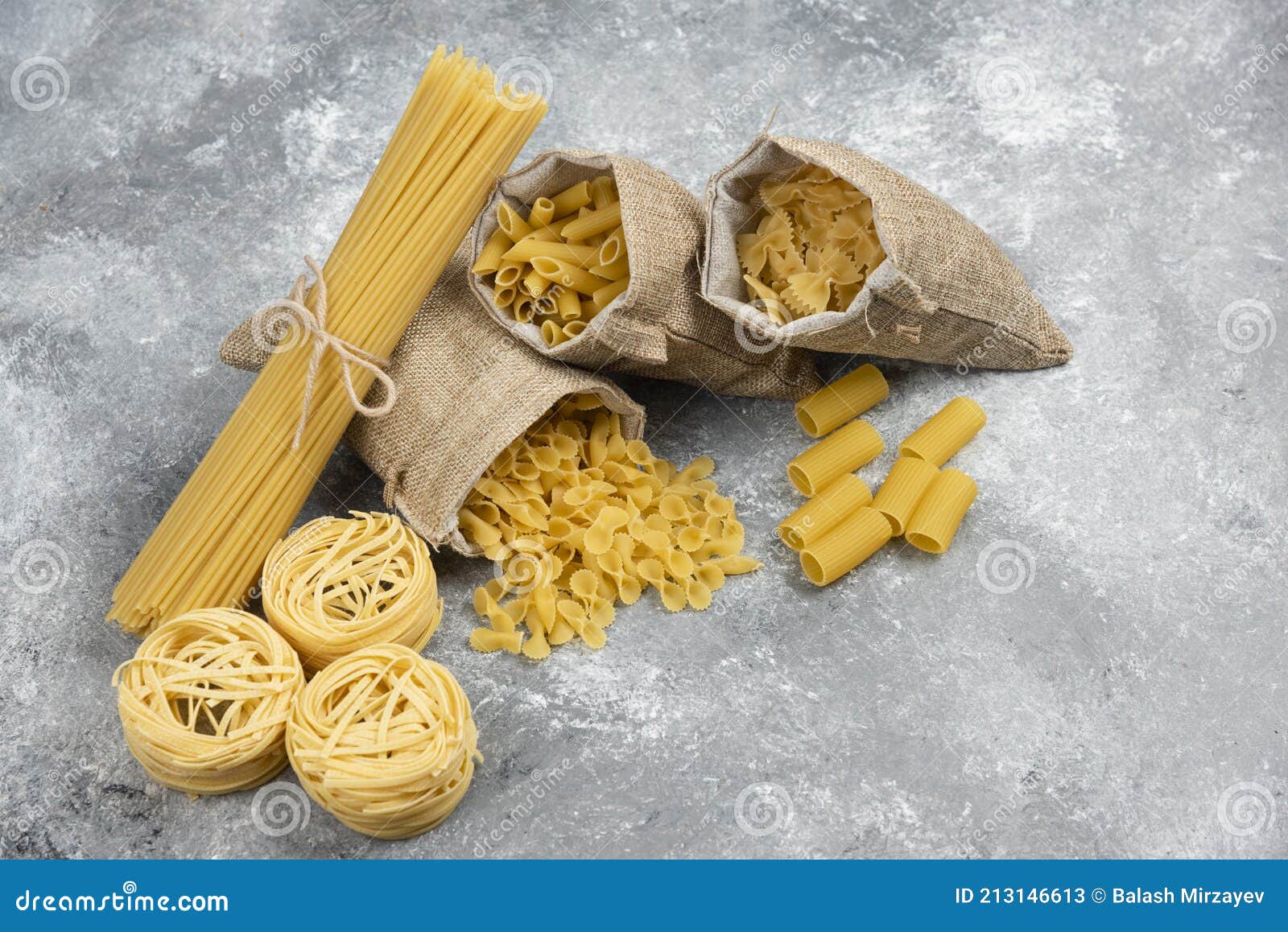 Noodle and Pasta Varieties in Rustic Baskets and Marble Background