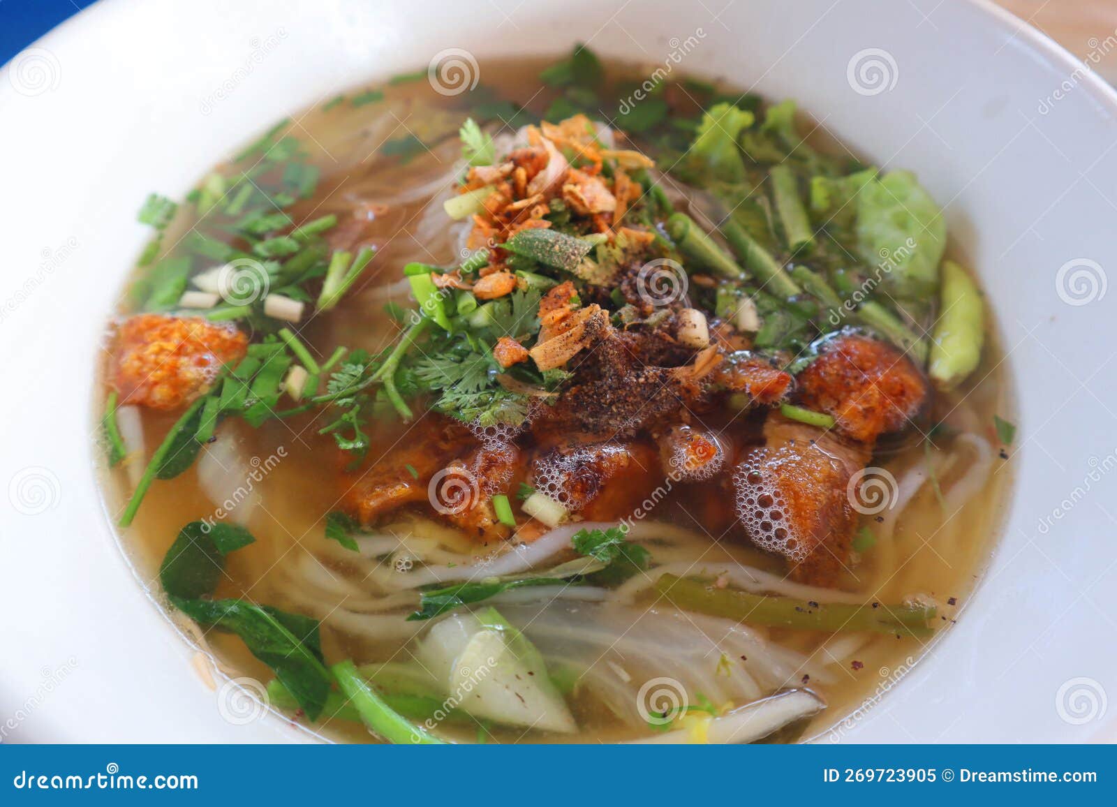 noodle soup with crispy pork and vegetables