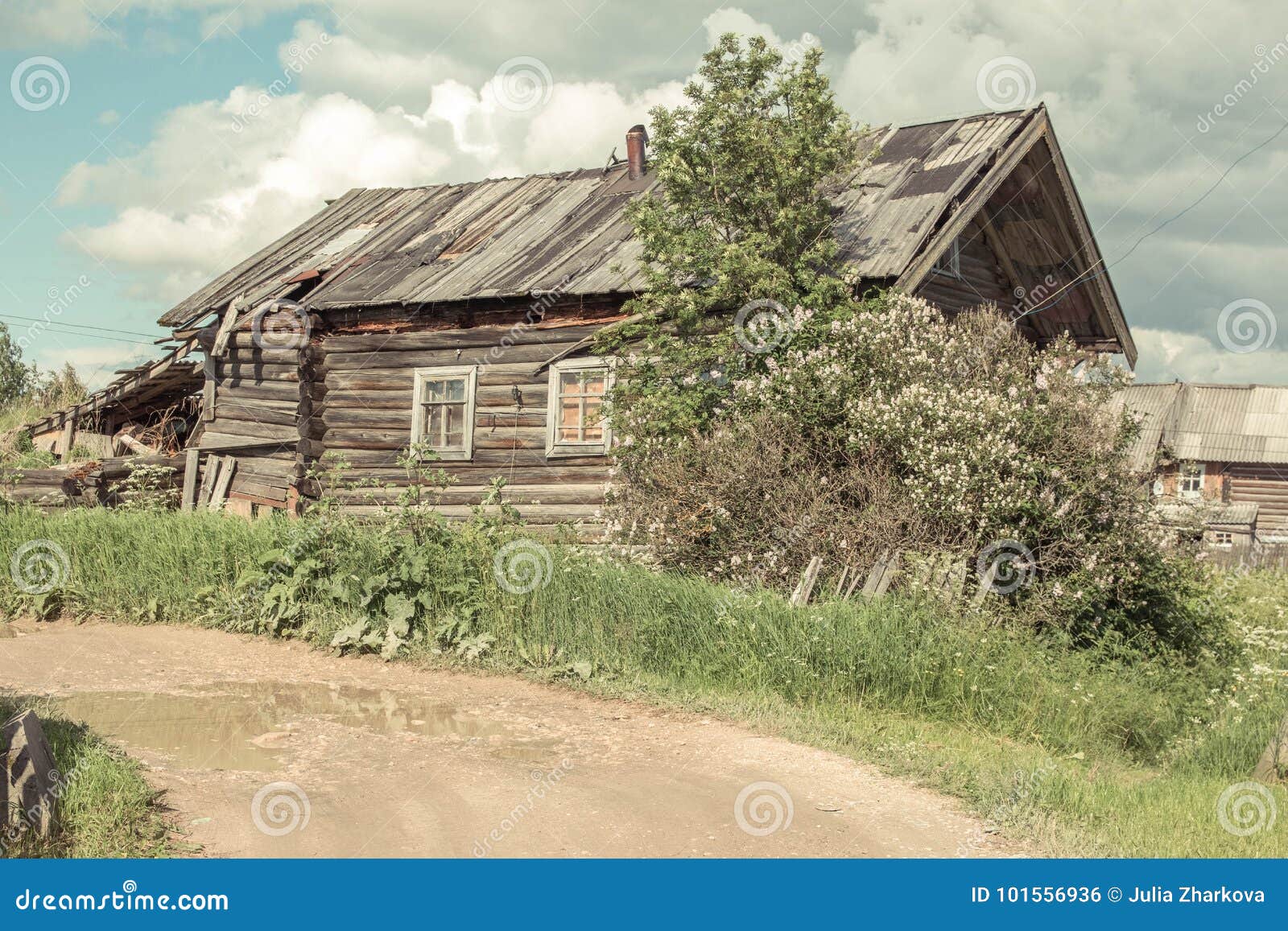 north russian village isady. summer day, emca river, old cottages on the shore, old wooden bridge. abandoned building.