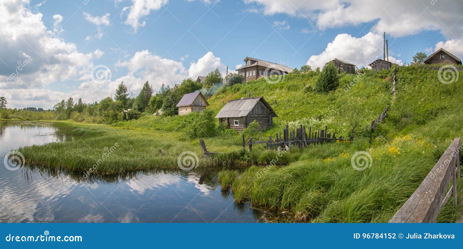north russian village. summer day, river, old cottages on coast.