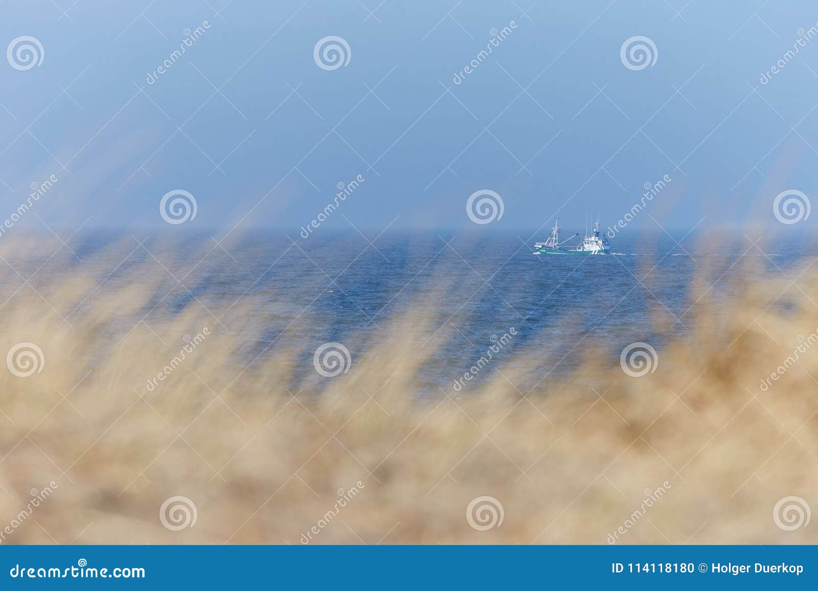 north sea coast in denmark with fishing boat editorial