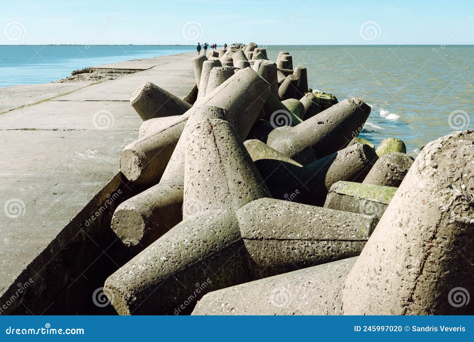 the northern breakwater in liepaja, a close-up of tetrapods and splashing, splattering waves. dolosse structure in the baltic sea