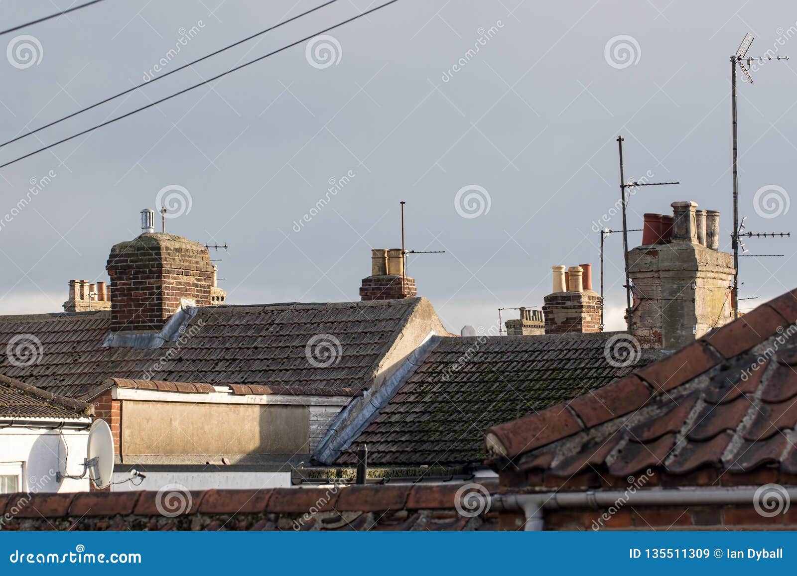 northern town tiled roof tops with chimneys and aerials uk