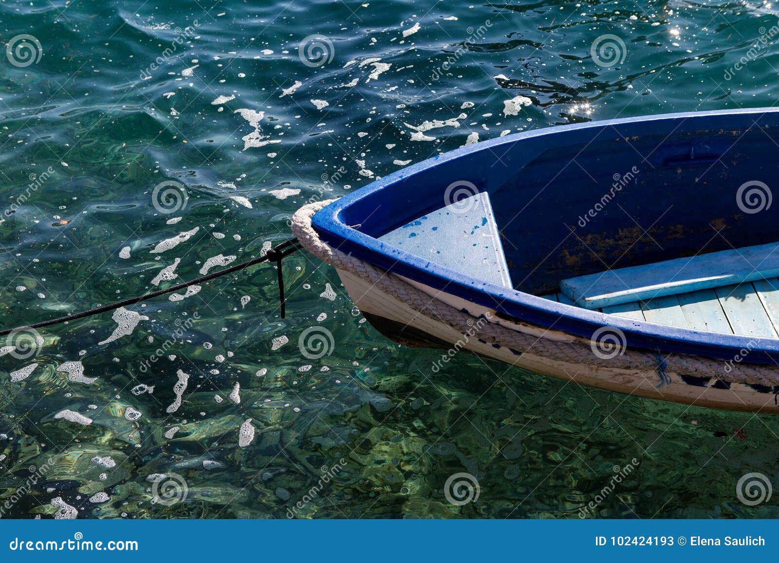 nos white blue small wooden fishing boats standing at the pier in clear water