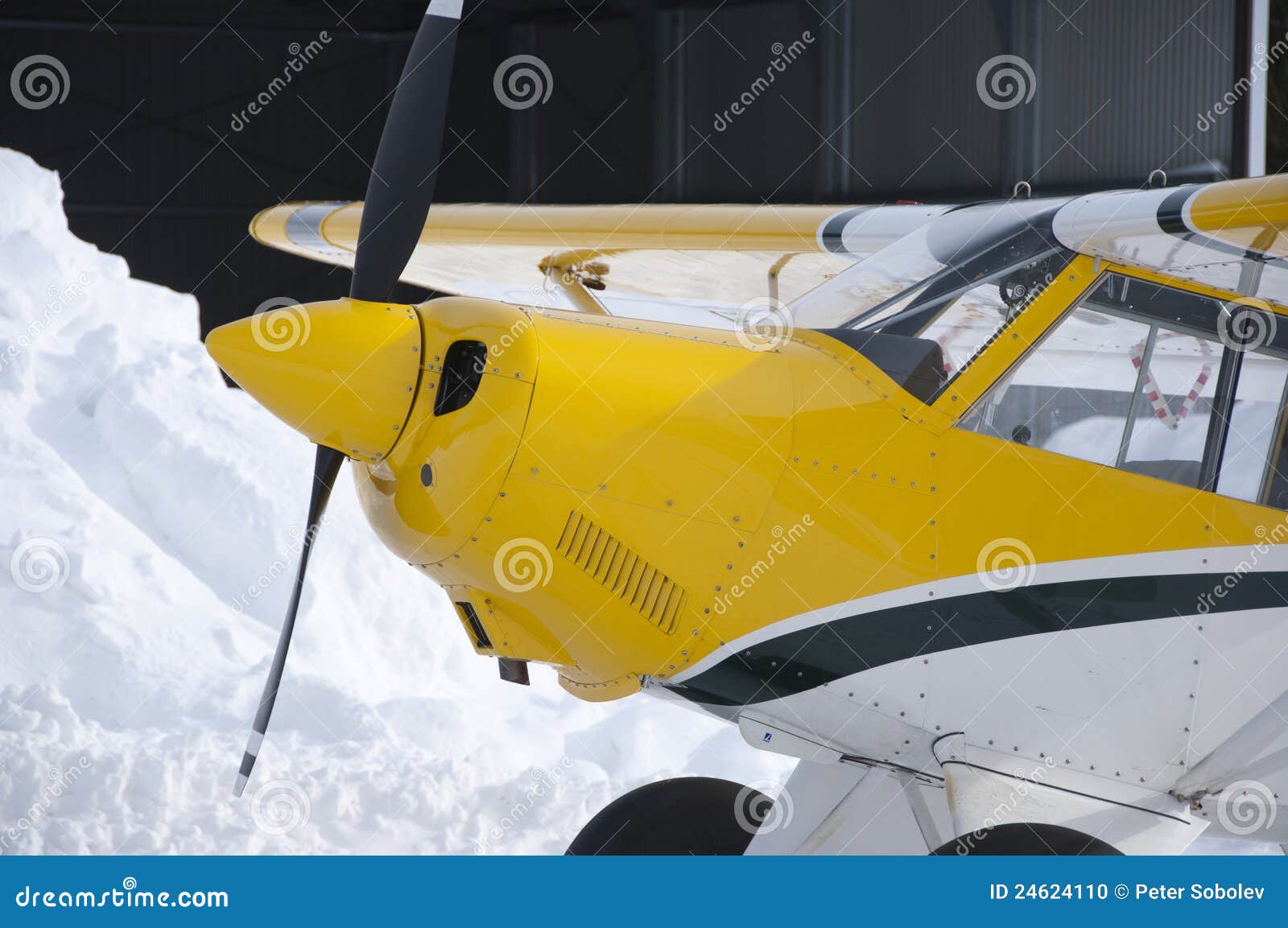 Nose and cockpit of light private aircraft. Winter season.