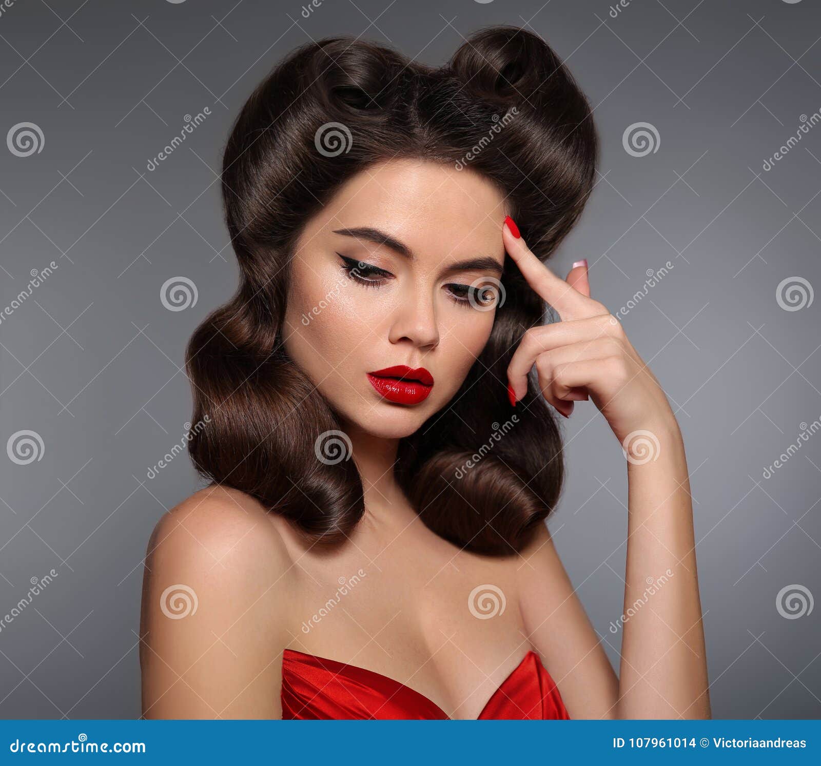 nostalgia. pin up girl with red lips makeup and retro curls hair