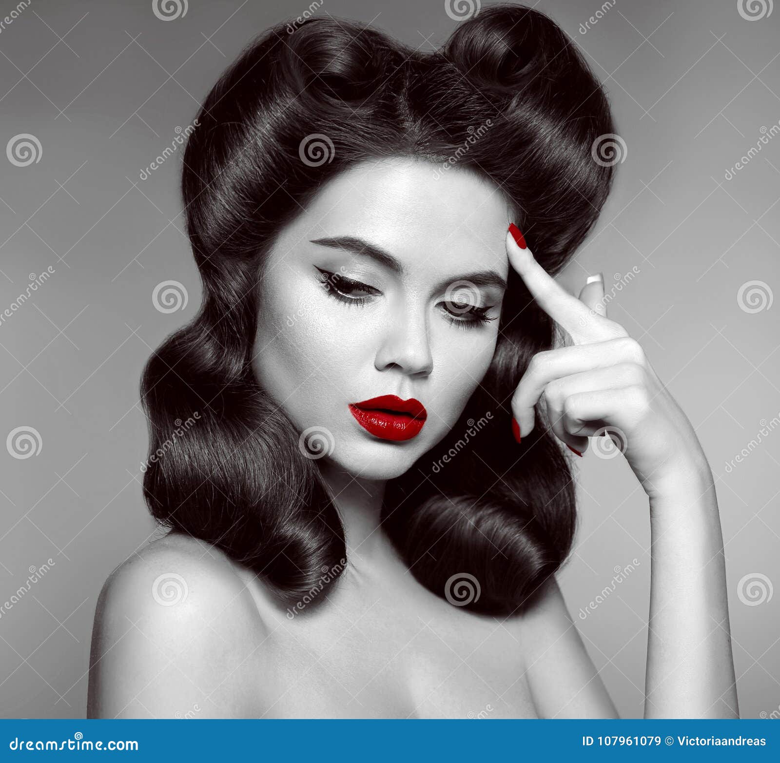 nostalgia. pin up girl with red lips makeup and retro curls hair