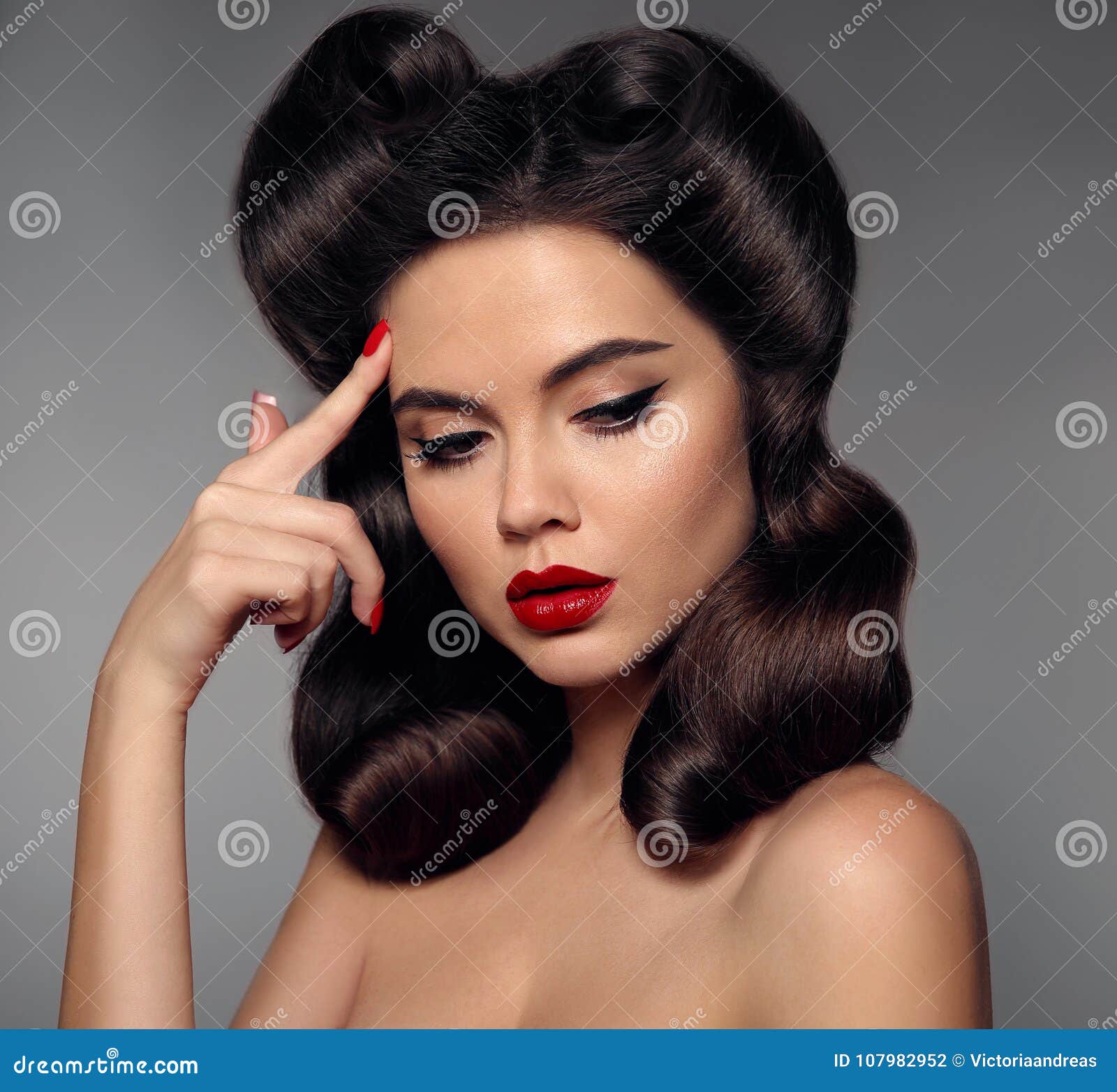 nostalgia. pin up girl with red lips makeup and retro curls hair