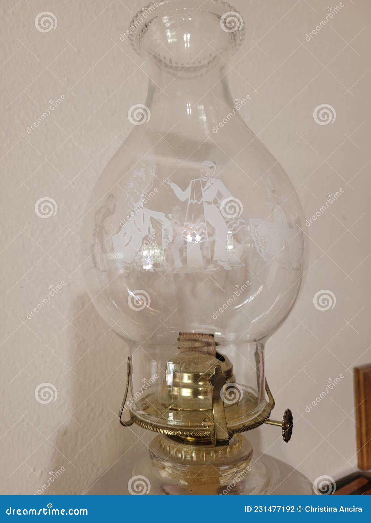 Nostalgic Old Fashioned Oil Lamp Bulb with White Figures Stock Photo