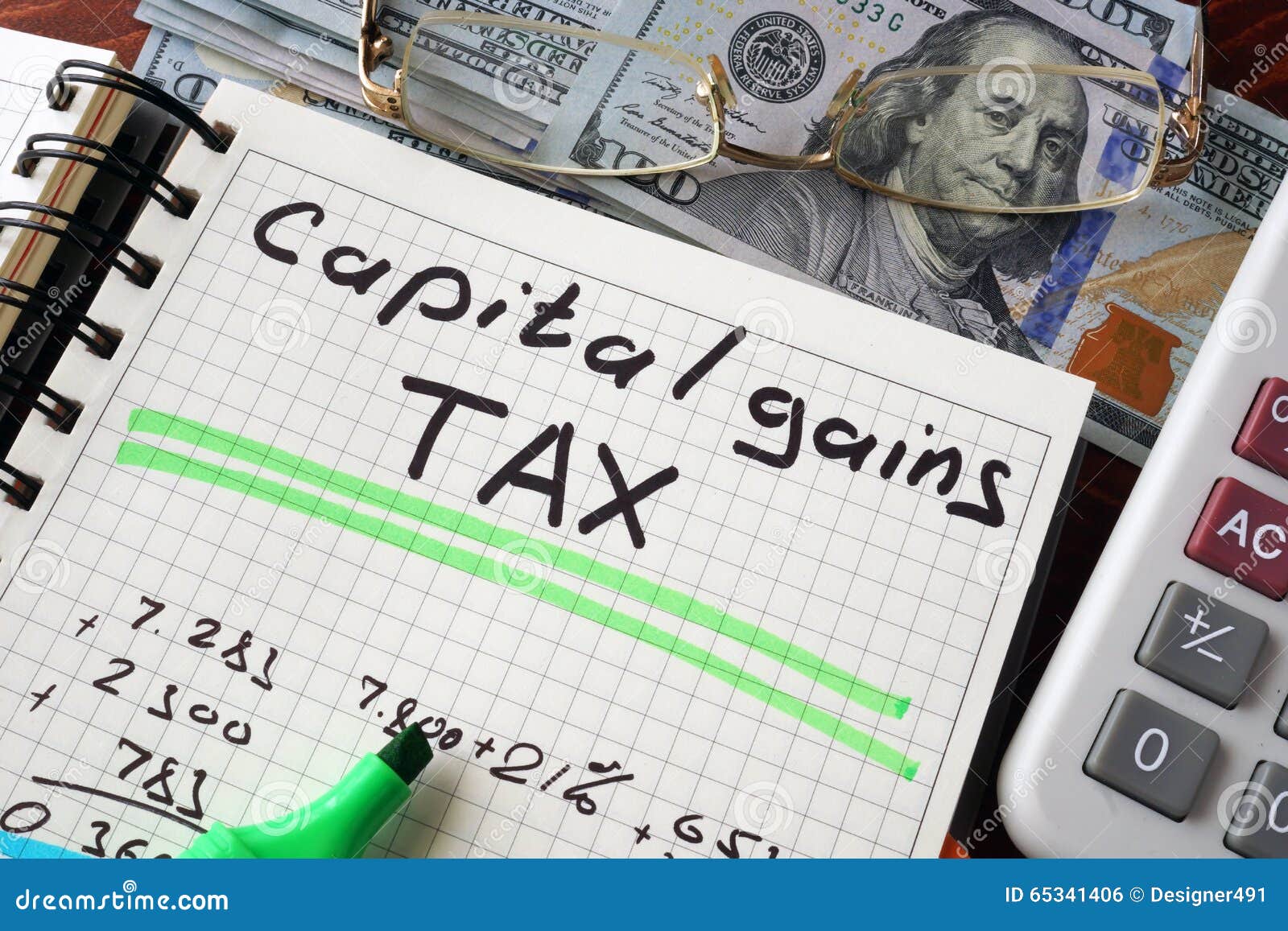 notebook with capital gains tax sign on a table.