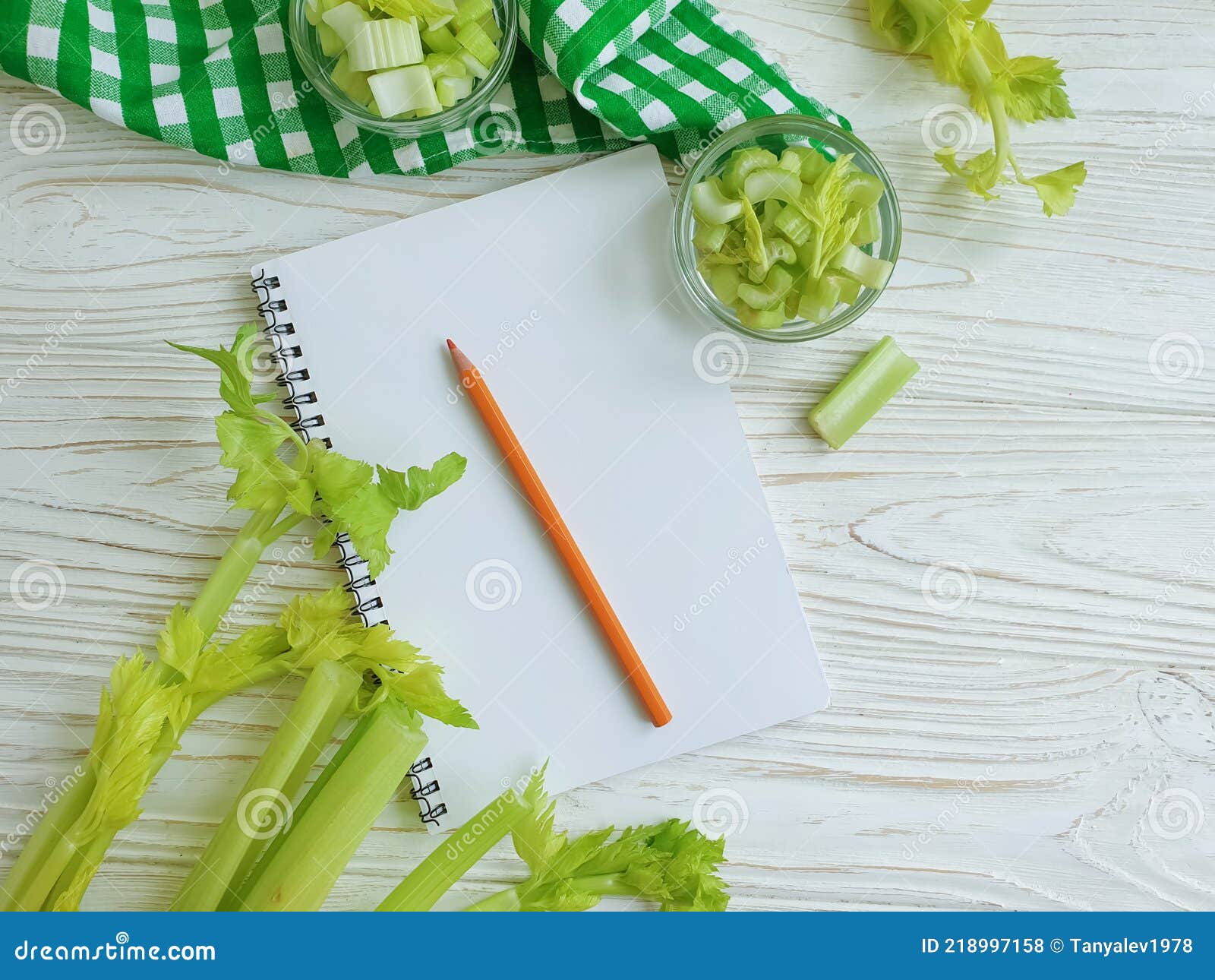 notebook celery  vegan on wooden backgroundn vitamin food