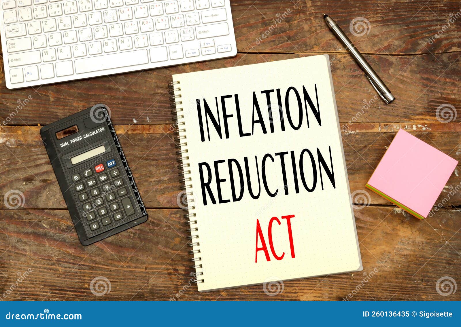 Notebook with Inflation Reduction Act Concept Near Calculator and
