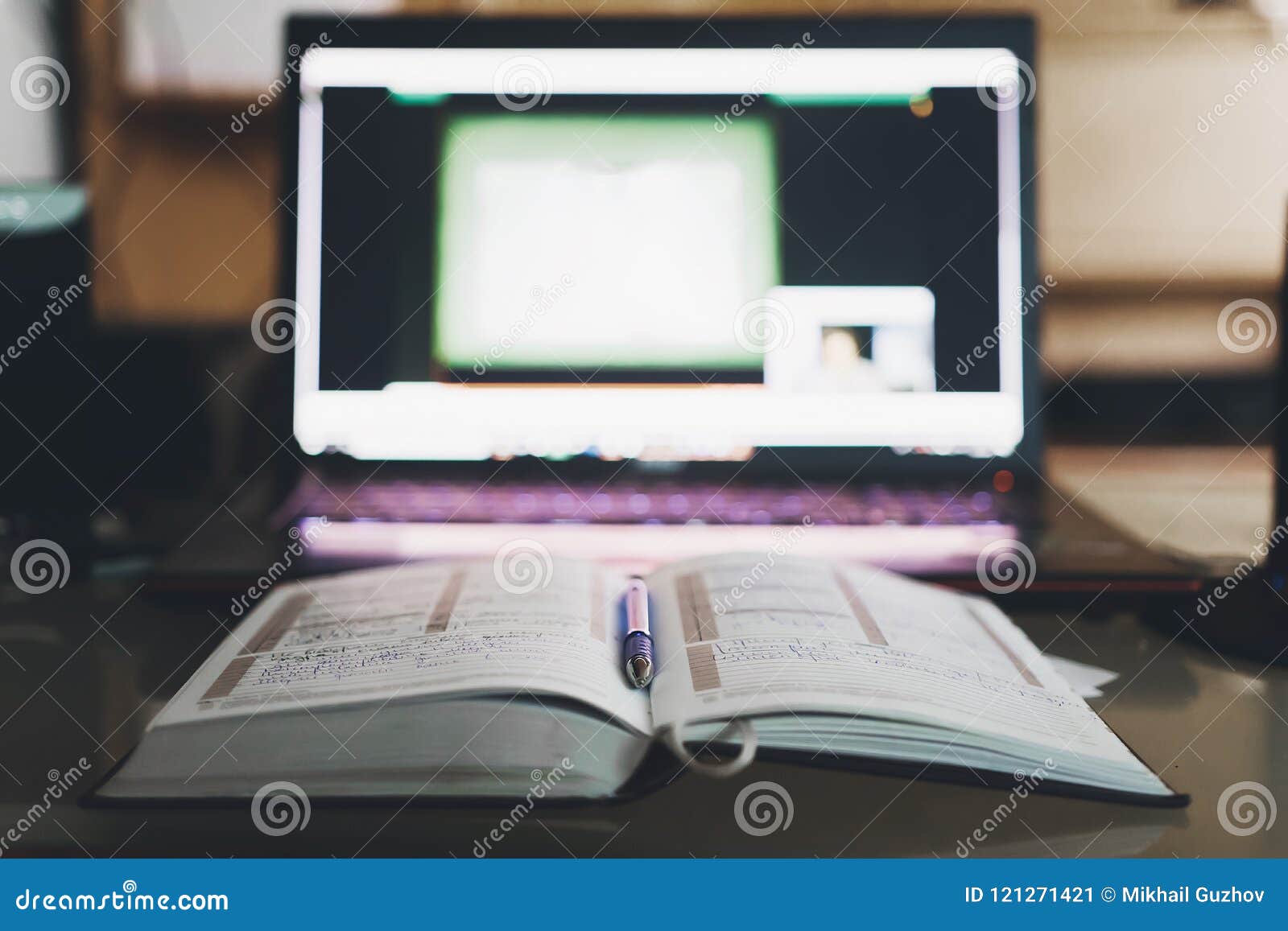 notebook lying next to the computer