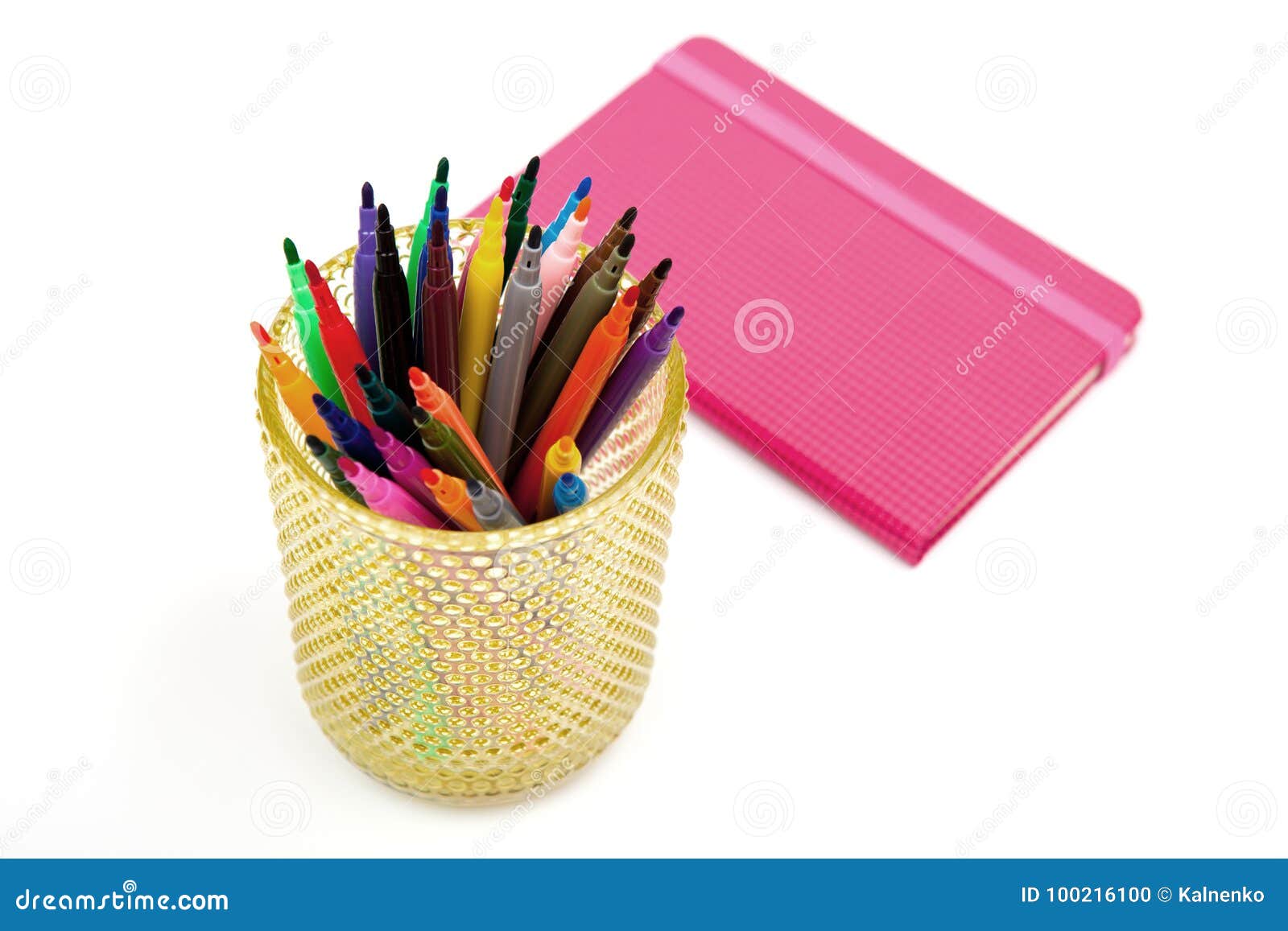notebook and multicolored markers on a white background