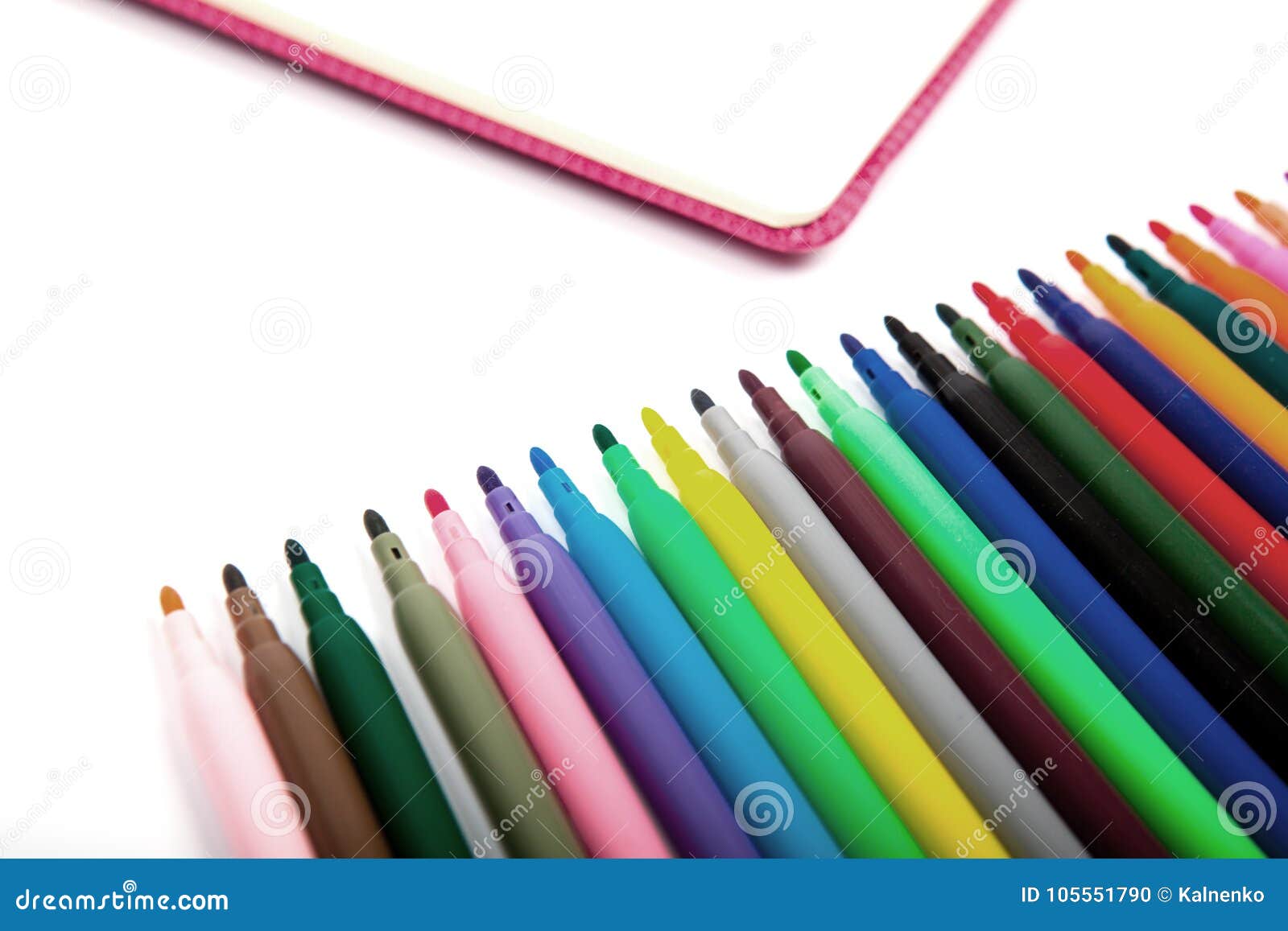 notebook and multicolored markers on a white background