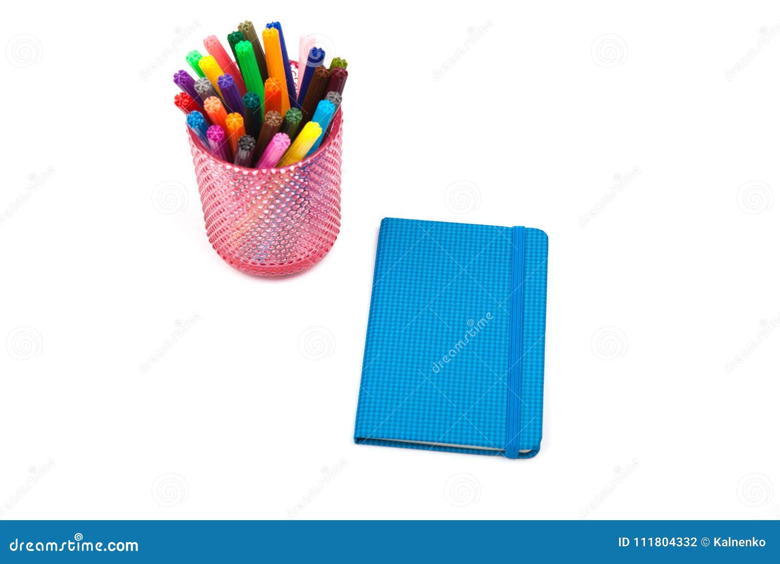 notebook and multicolored markers on a white background