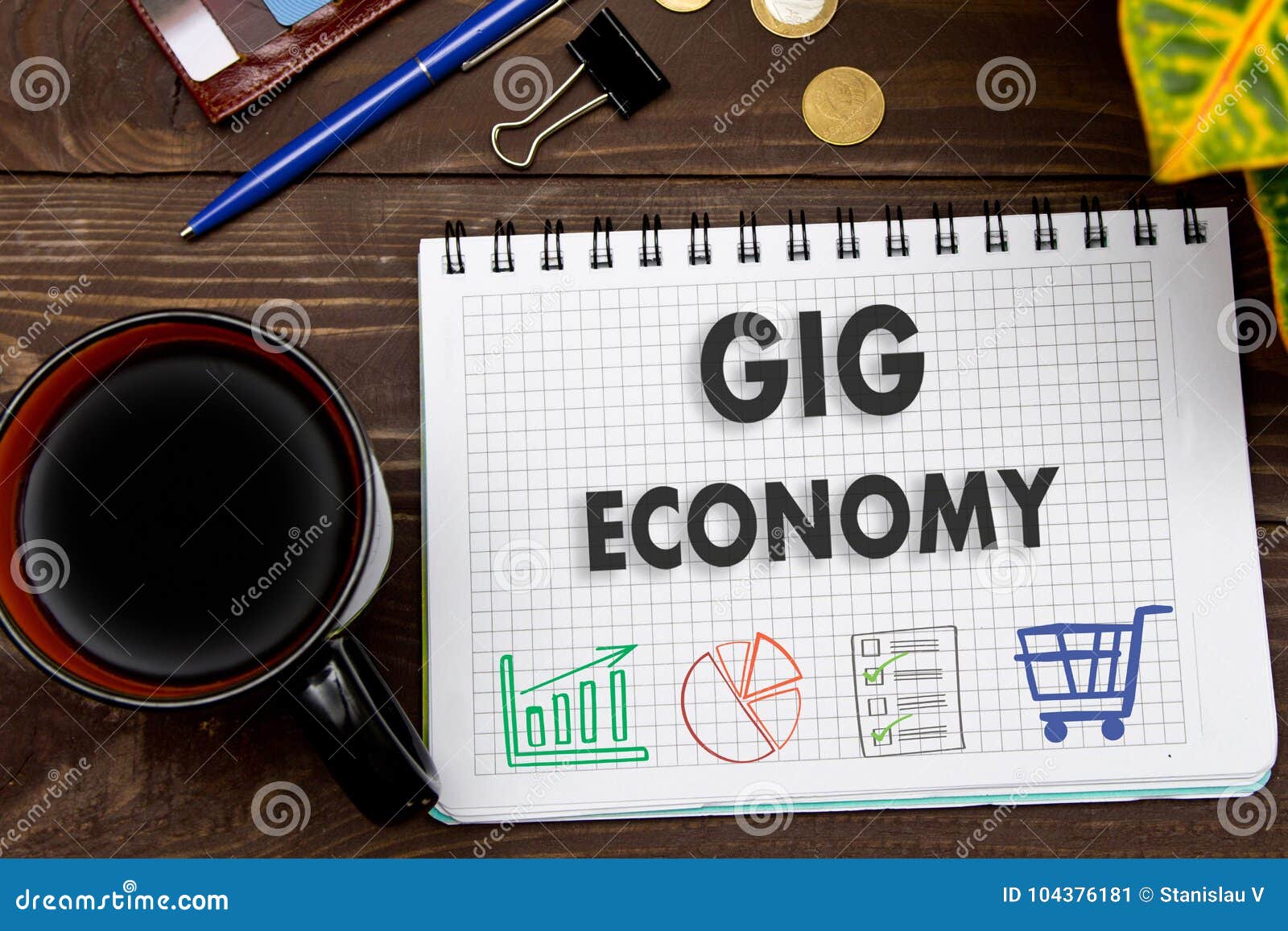 notebook with a notes gig economy on the office table with tools