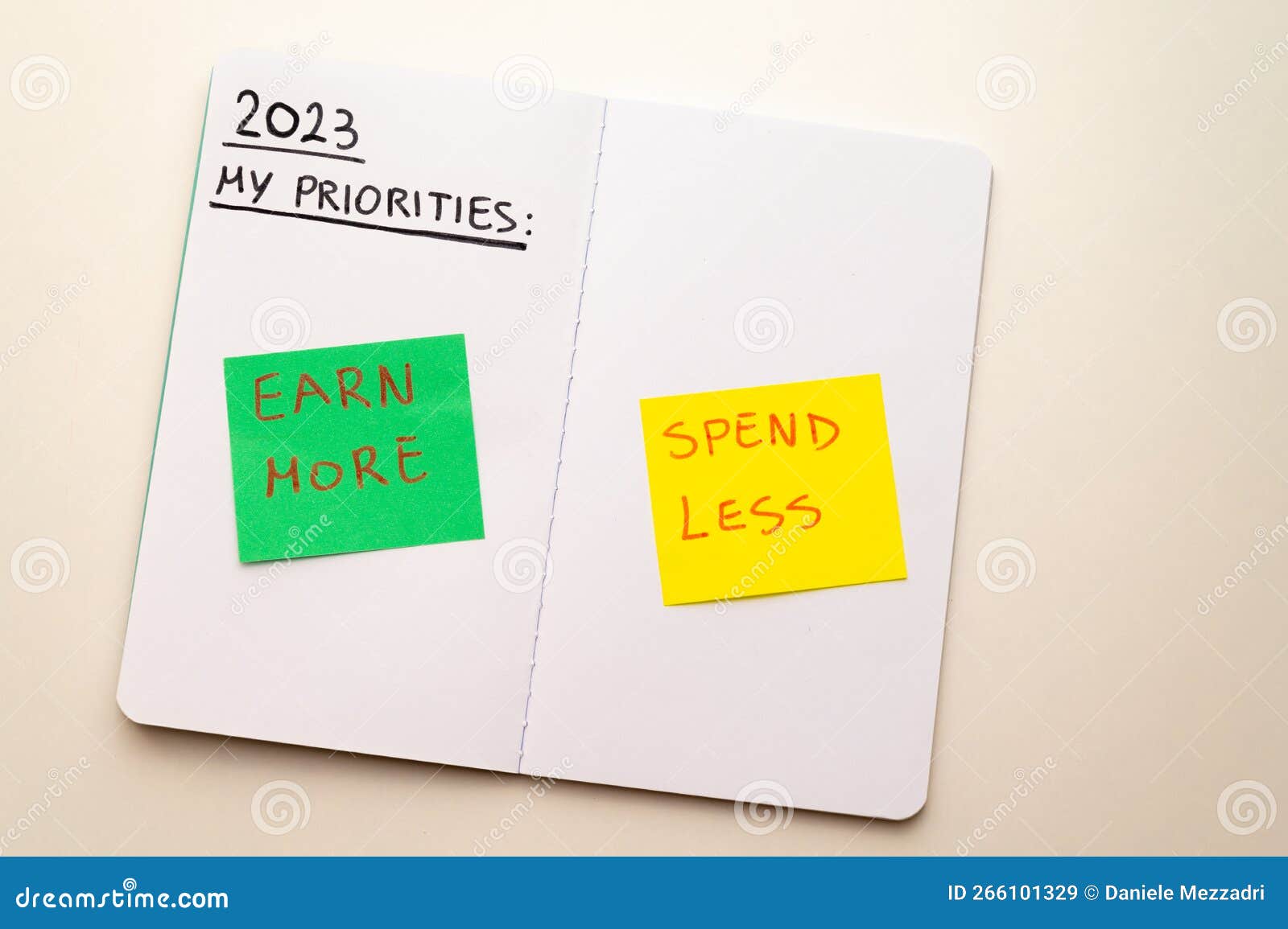 notebook page, with text `2023 priorities: spend less, earn more`