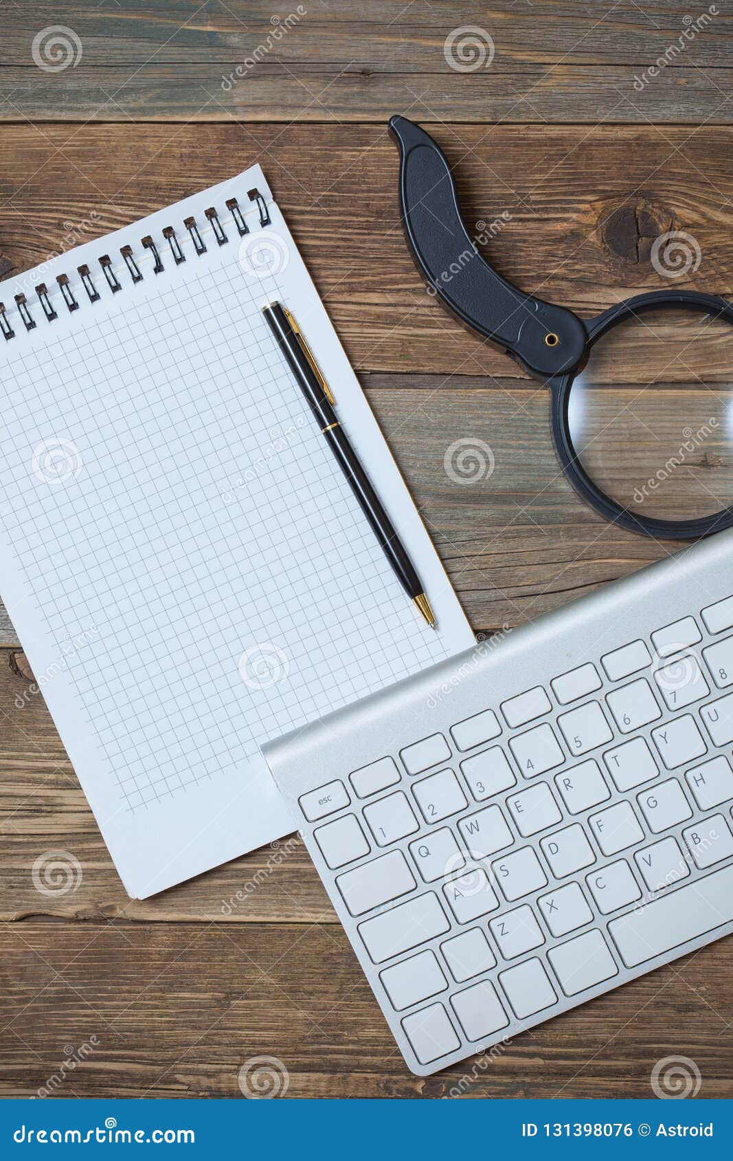 Notebook for Taking Notes, Pen, Magnifying Glass and Computer Keyboard