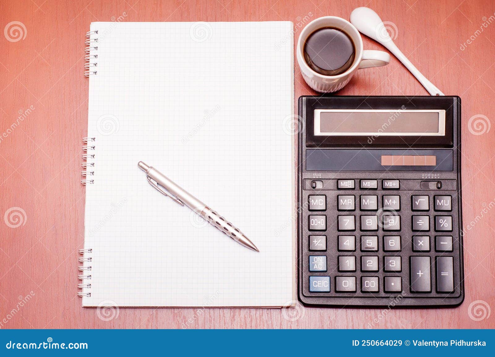 Notepad, Pen, Calculator and White Cup with Coffee on the Table Stock