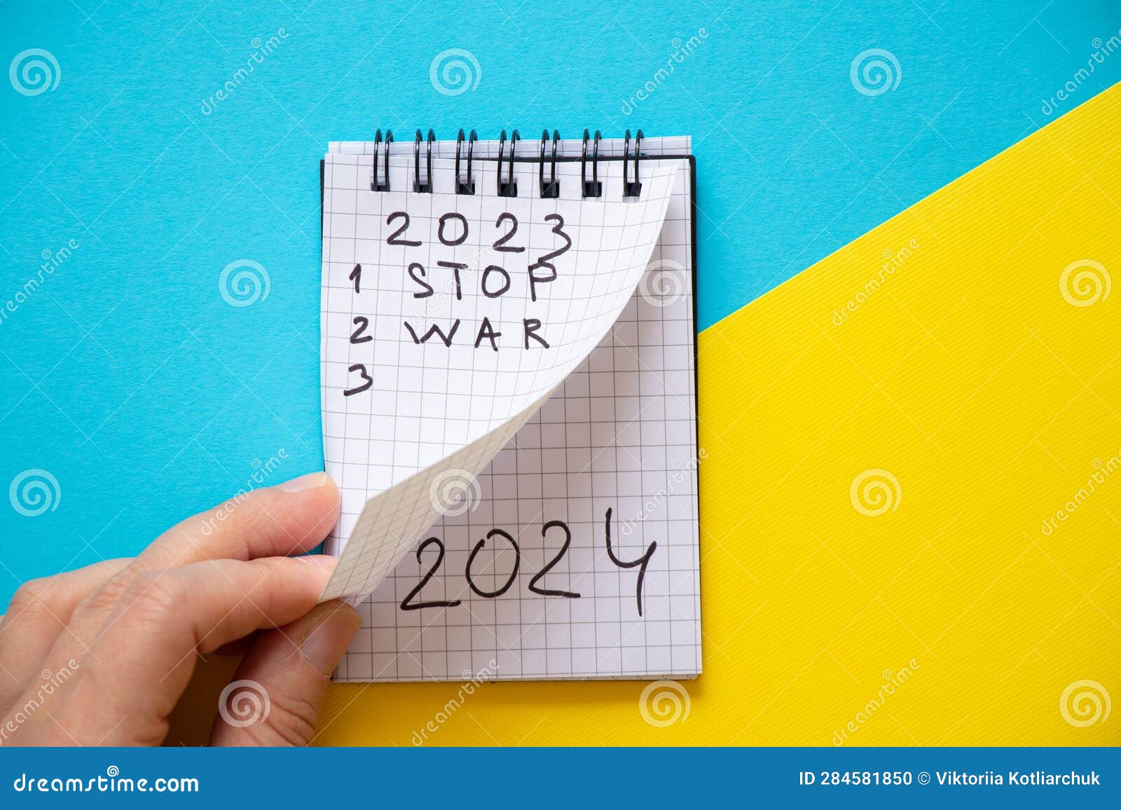 Notepad with the Text 2023 and the Text Stop War and 2024 on the Second