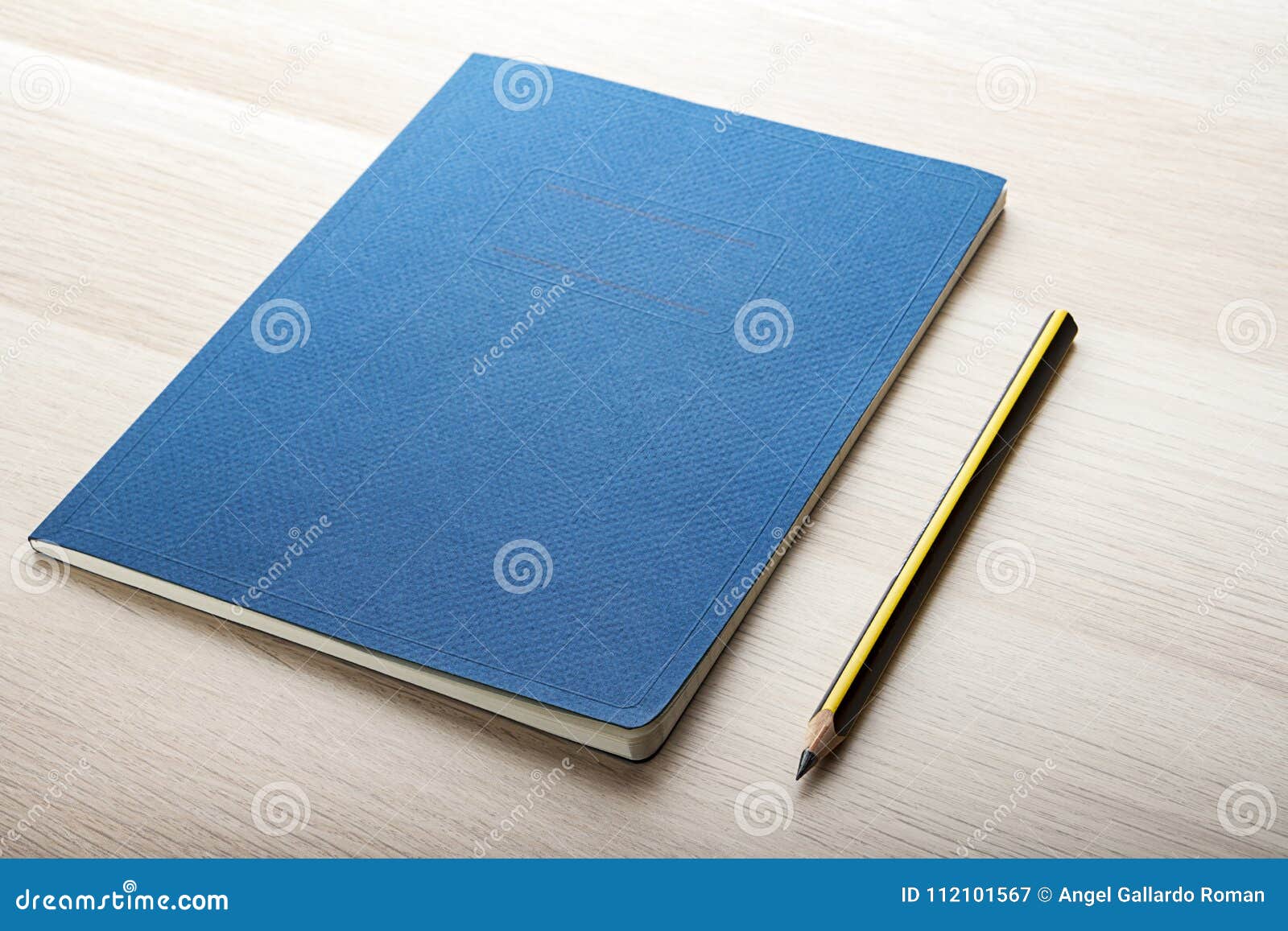 notepad on wooden desk with pencil