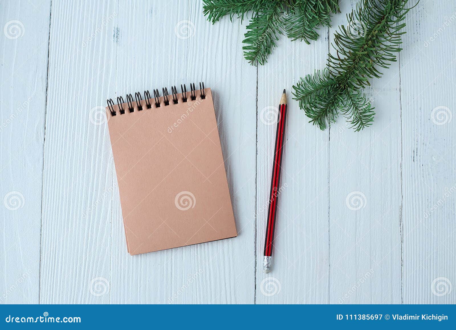 Download A Notepad A Wooden Table Near The Christmas Tree Notebook To Stock Image