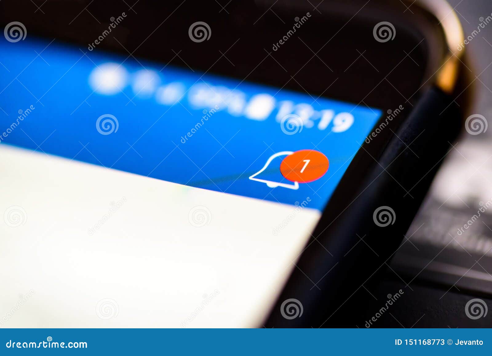 notification bell button on smartphone app screen closeup